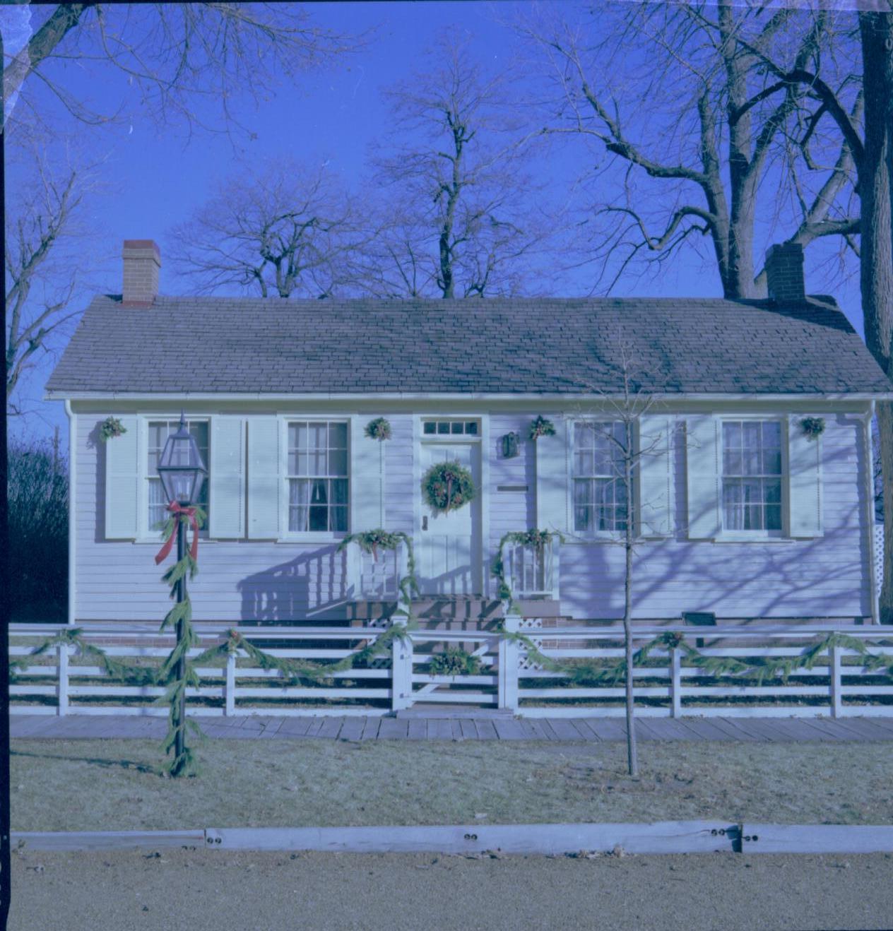 Lincoln Home NHS- Christmas in Lincoln Neighborhood Looking east from 8th Street, west face of Corneau house decorated for Christmas. Christmas, decorations, Corneau, decor, wreath, garland, fence