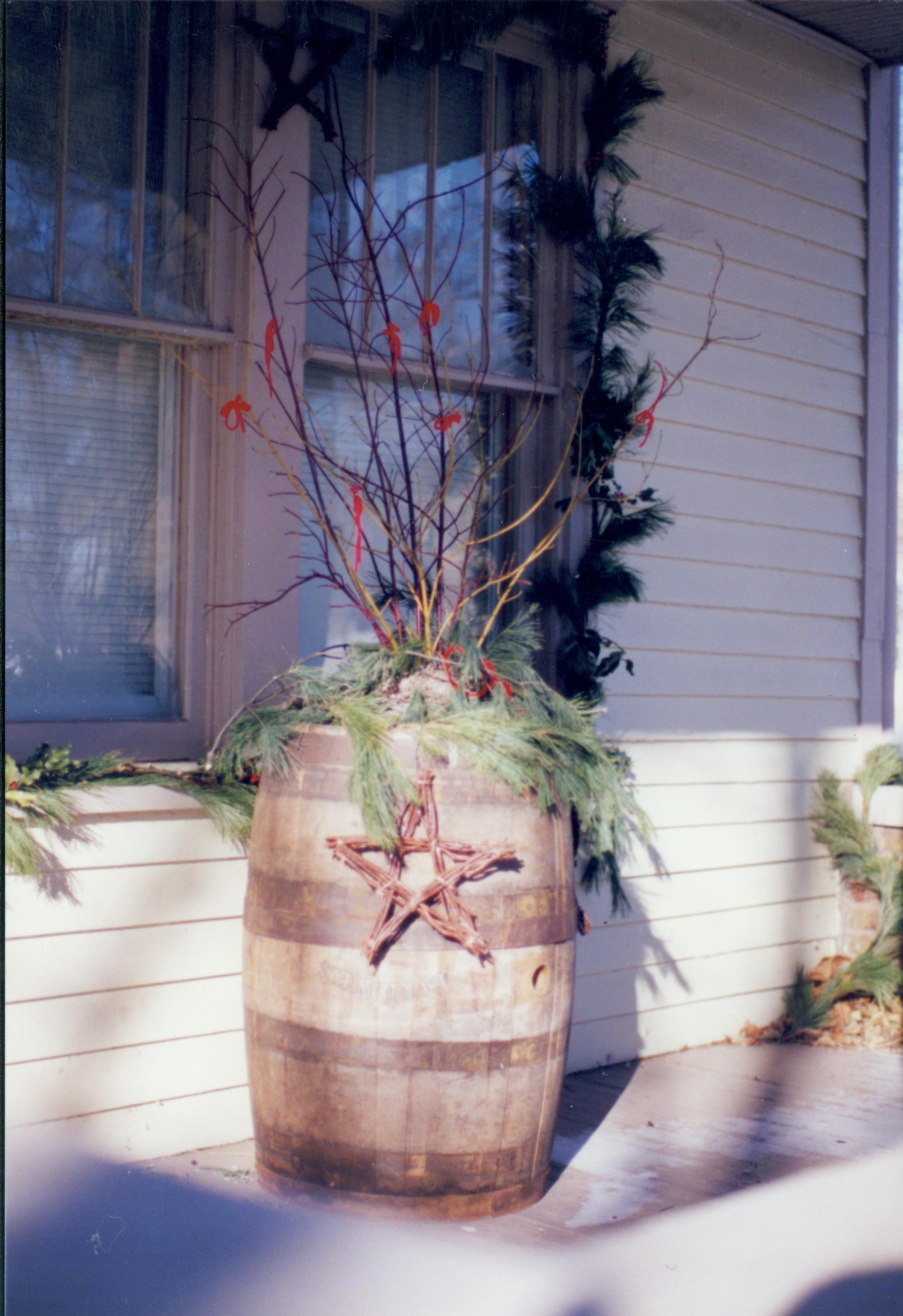 Lincoln Home NHS- Christmas in Lincoln Neighborhood Looking north west, detail of Christmas decor in barrel on house porch. Christmas, neighborhood, decor, porch, garland