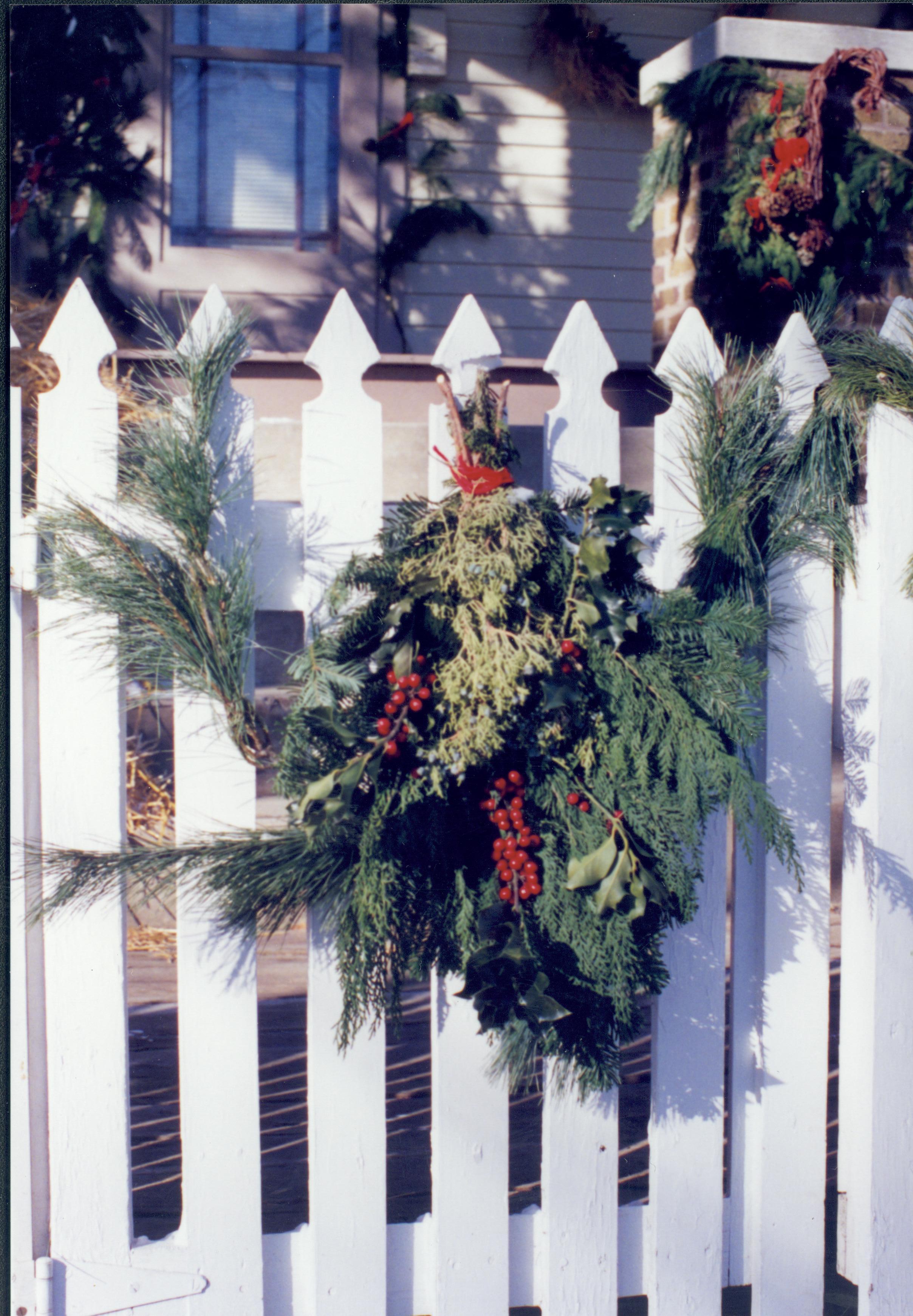 Lincoln Home NHS- Christmas in Lincoln Neighborhood Christmas wreath on fence; garland on brick wall in background. Detail. Christmas, neighborhood, fence, brick, garland, wreath, detail