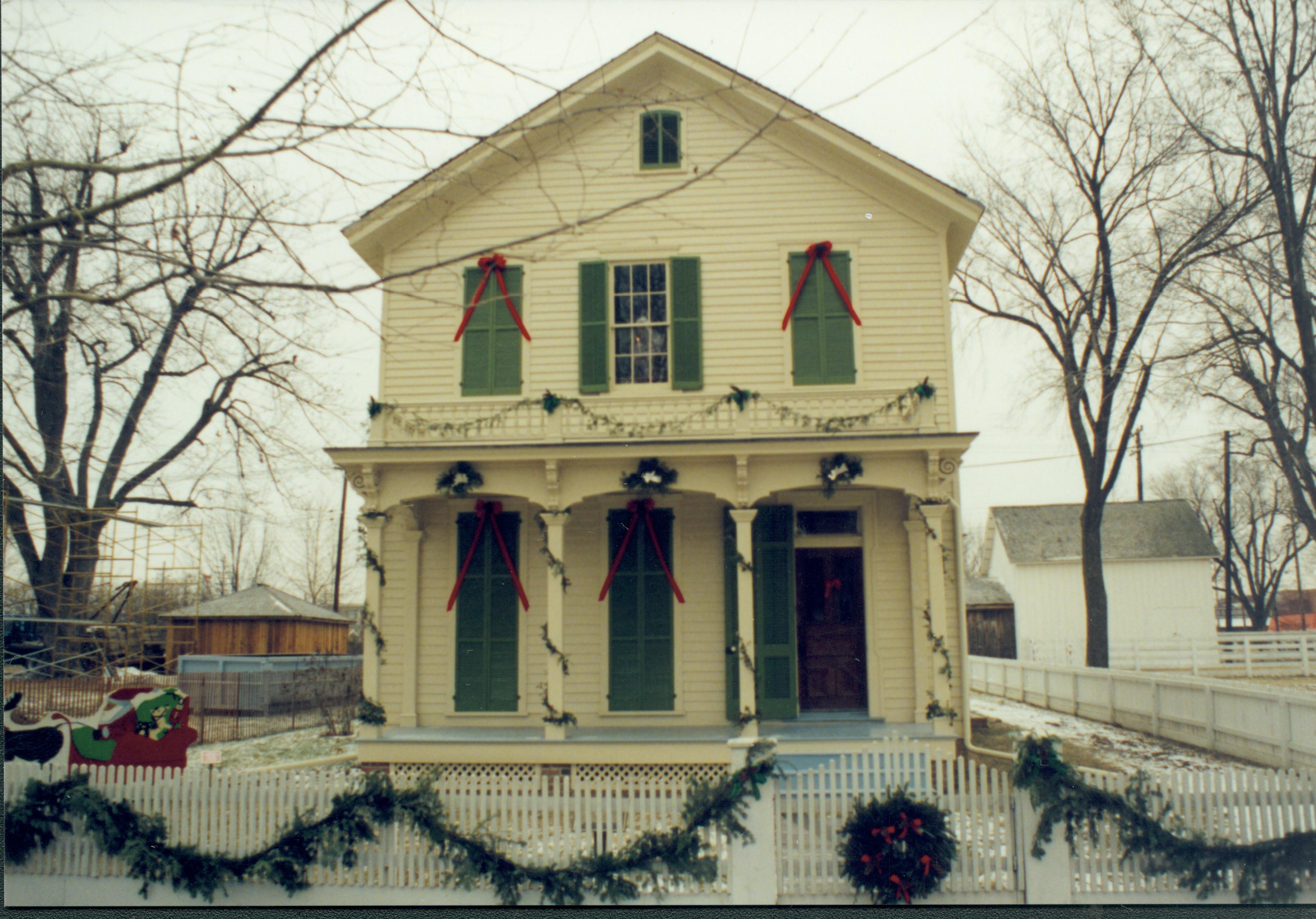 Lincoln Home NHS- Christmas in Lincoln Neighborhood Looking east from 8th Street toward Robinson house and lot. Individual in window. Christmas, neighborhood, Robinson, decoration