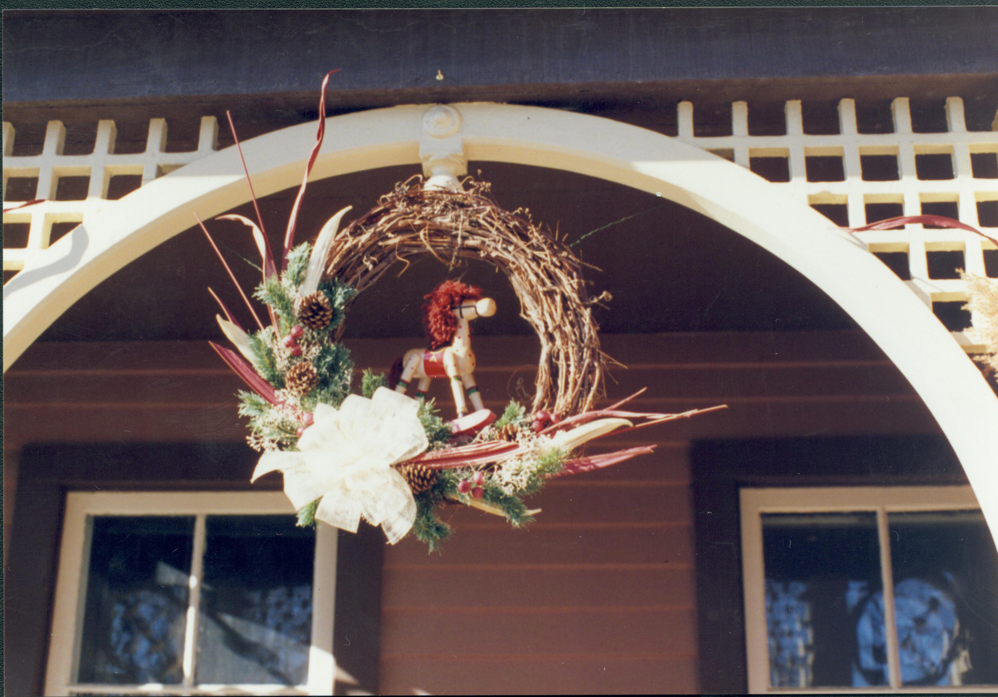 Lincoln Home NHS- Christmas in Lincoln Neighborhood Looking west, Christmas wreath hanging from Dean house porch. Detail. Christmas, neighborhood, wreath, detail, Dean, porch