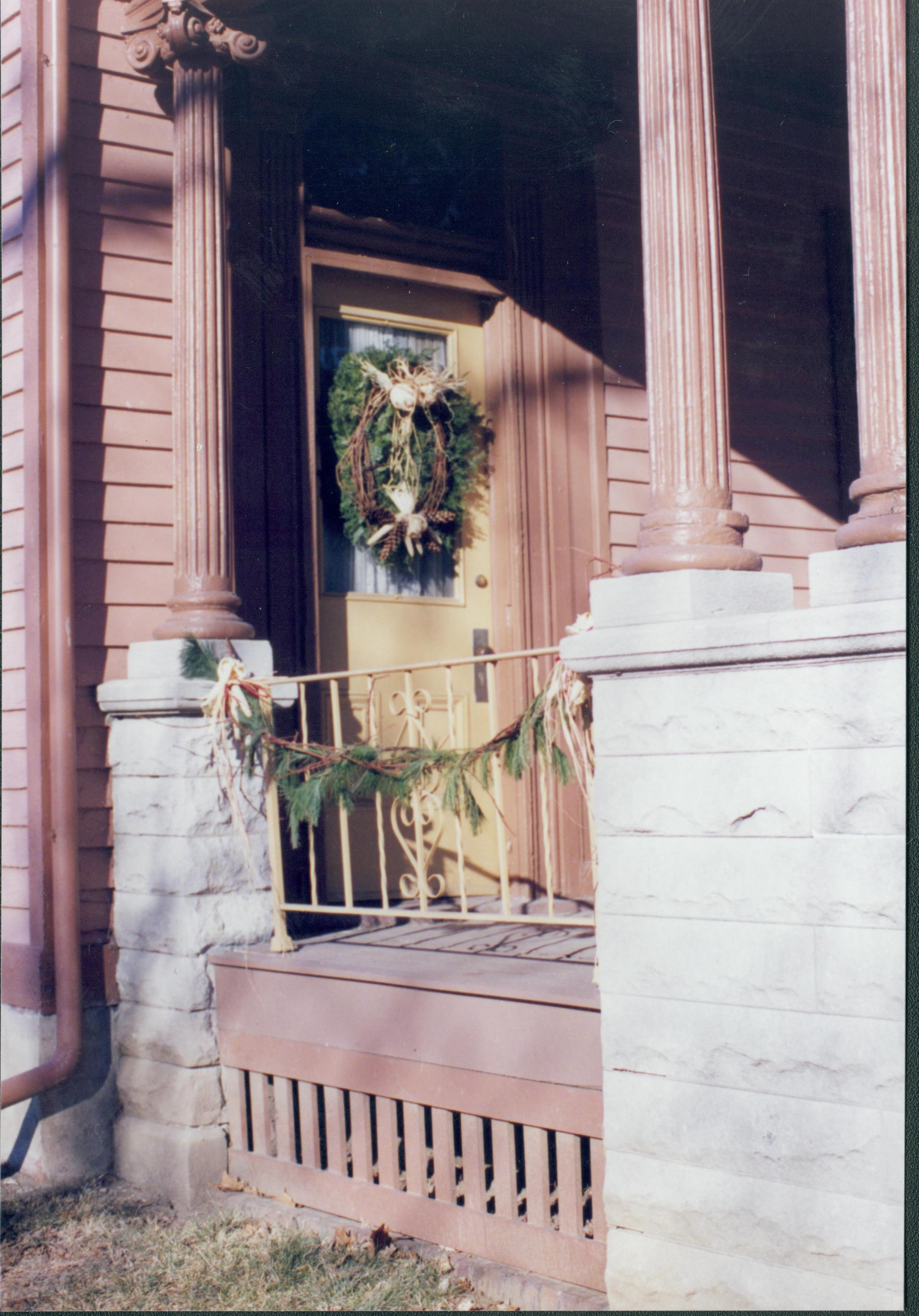 Lincoln Home NHS- Christmas in Lincoln Neighborhood Looking north west, Christmas wreath and garland on house door and porch. Detail. Christmas, neighborhood, detail, decor, wreath, garland