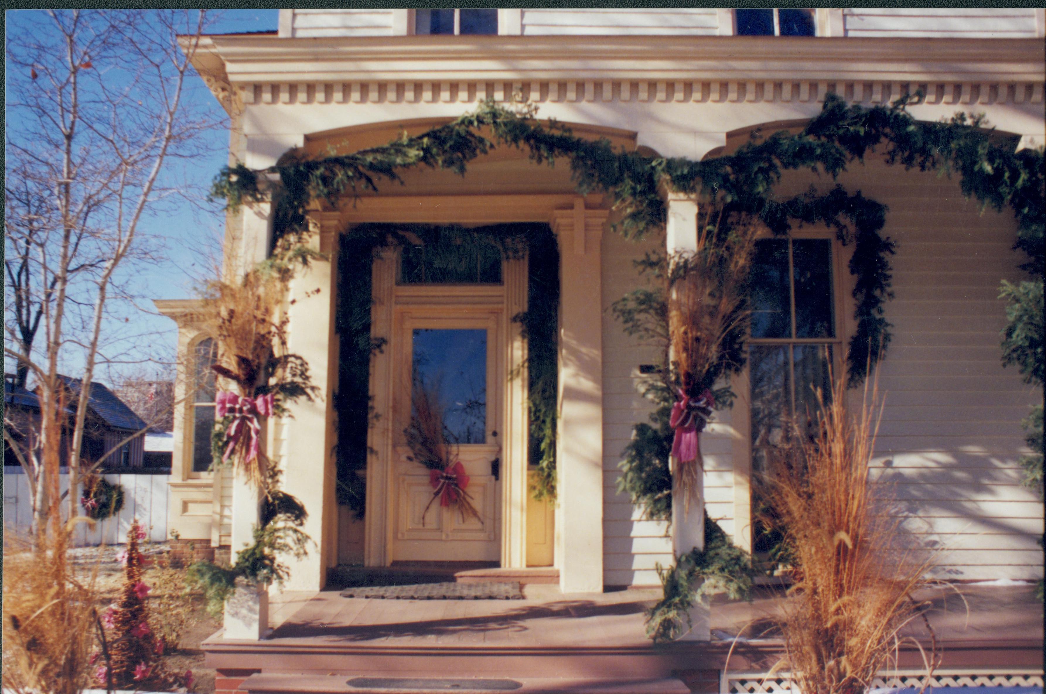 Lincoln Home NHS- Christmas in Lincoln Neighborhood Looking west, garland and wreaths on porch and door of Lyon house. Christmas, neighborhood, Lyon, Rosenwald, wreath, garland, porch