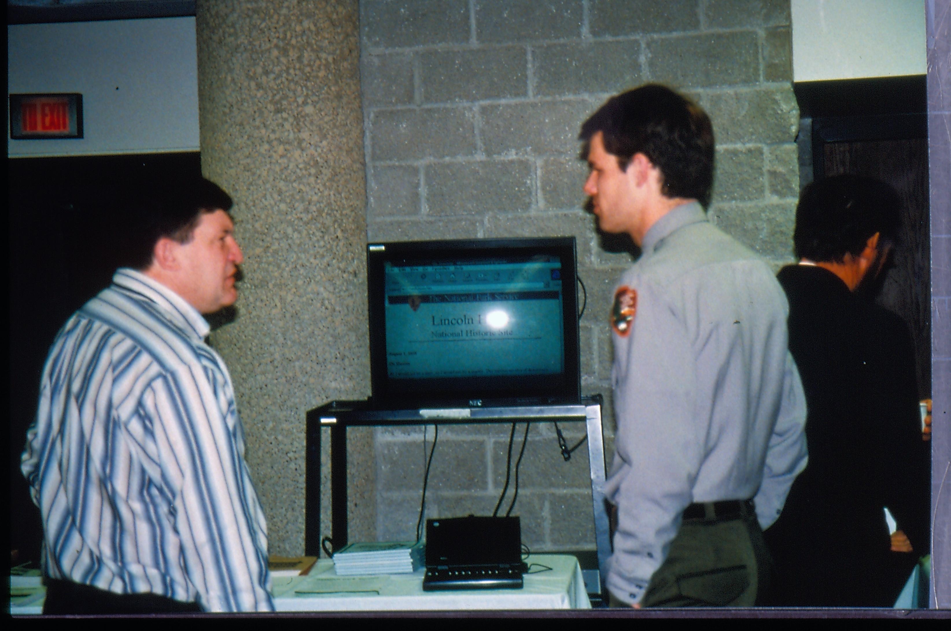 Ranger and attendee by video monitor. 1997 Colloq (color slides) Colloquium, 1997