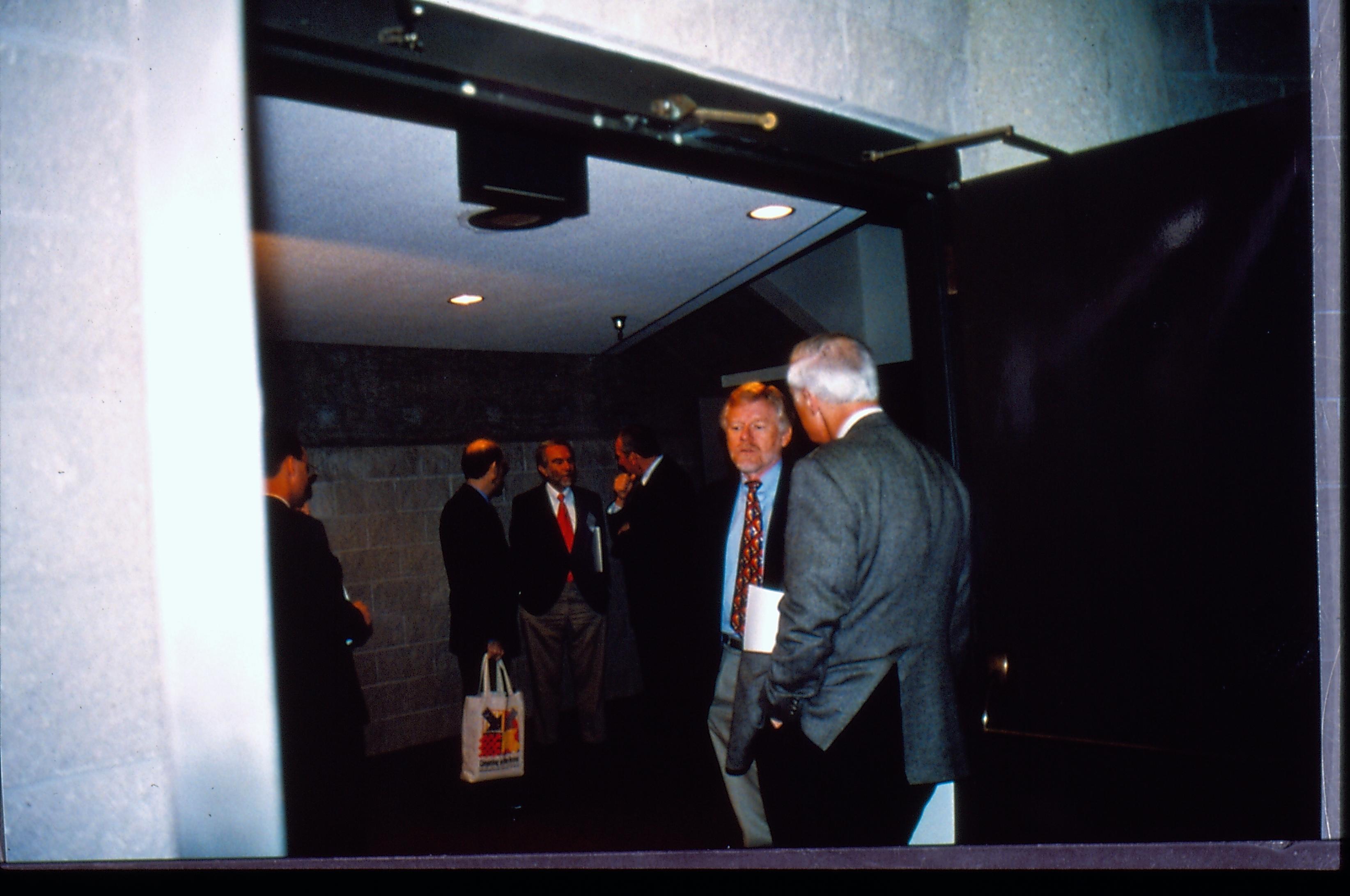 Two men talking in doorway. 1997 Colloq (color slides) Colloquium, 1997