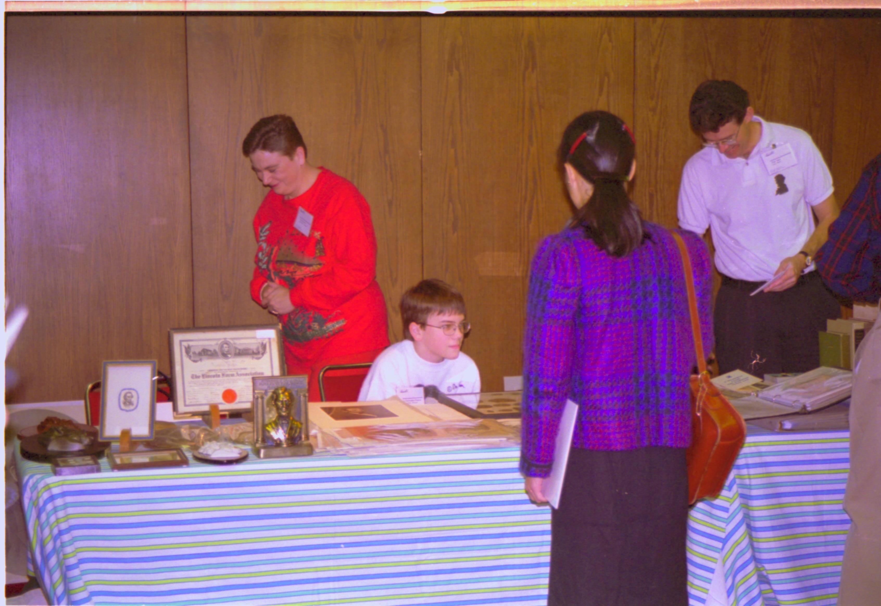 Exhibitors and guests at sales table. 4-1997 Colloq (color); 15 Colloquium, 1997