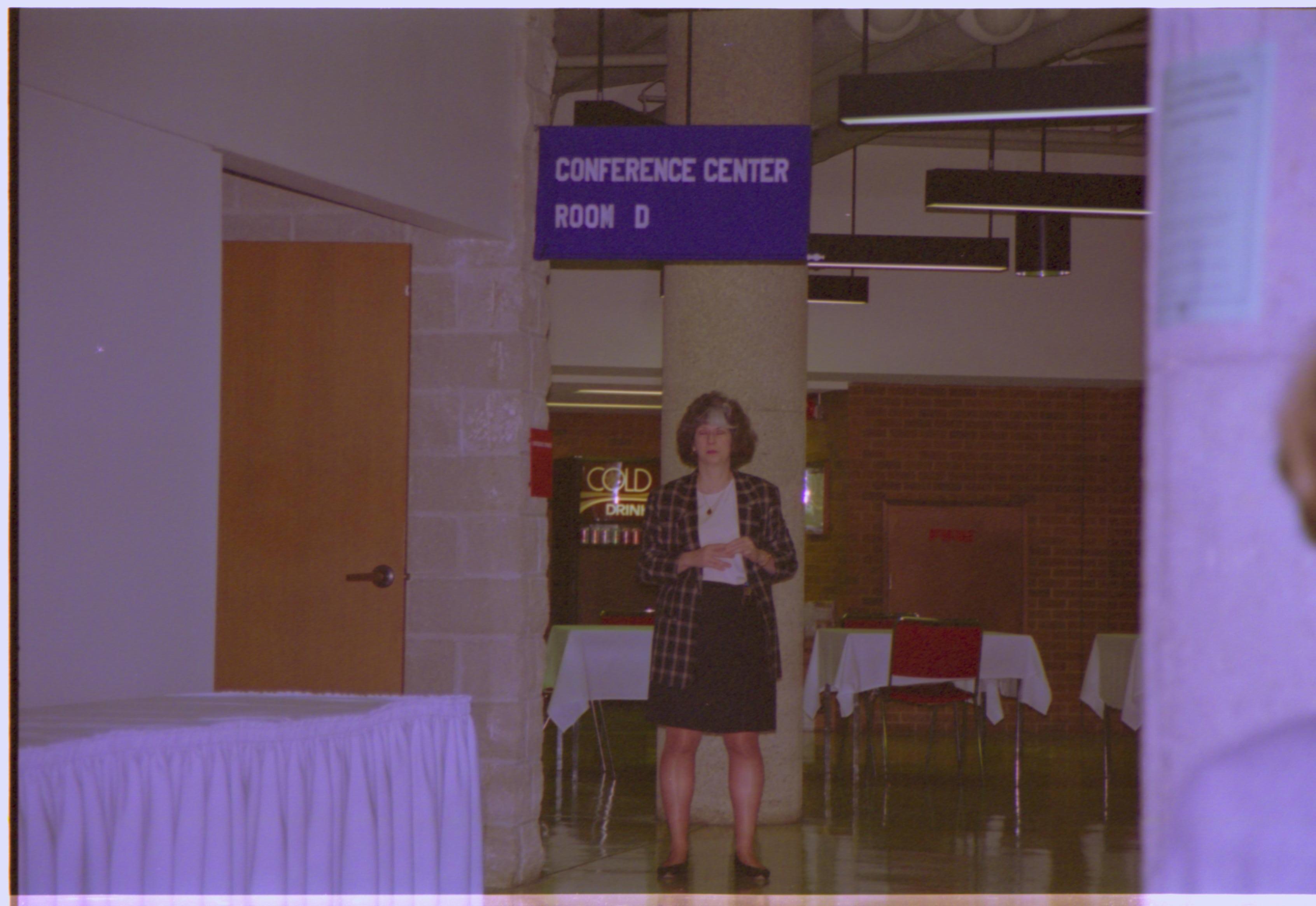 Lady standing in front of pillar 4-1997 Colloq (color); 18 Colloquium, 1997