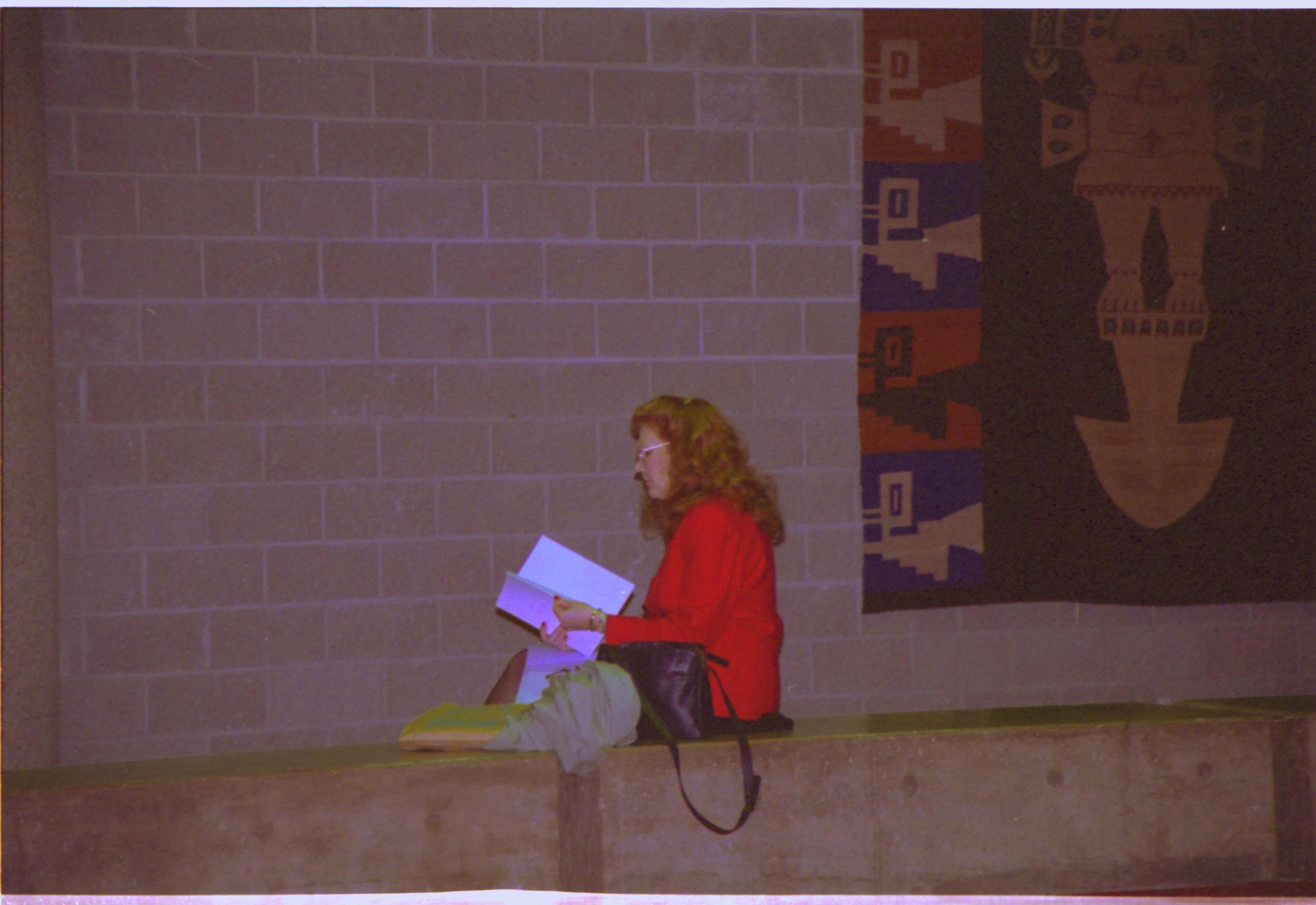 Lady seated reading book. 4-1997 Colloq (color); 19 Colloquium, 1997