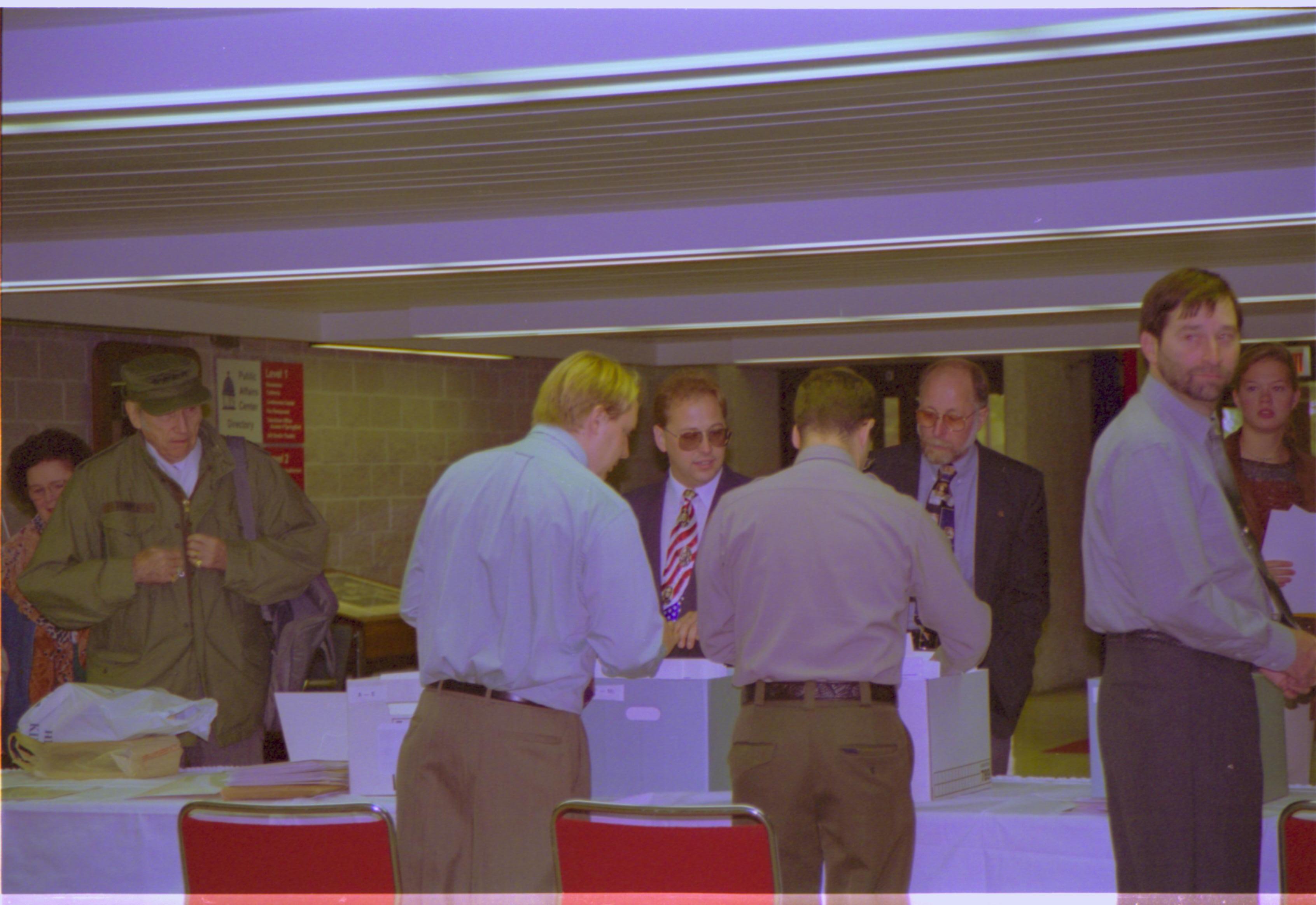 Attendees check in. 4-1997 Colloq (color); 26 Colloquium, 1997