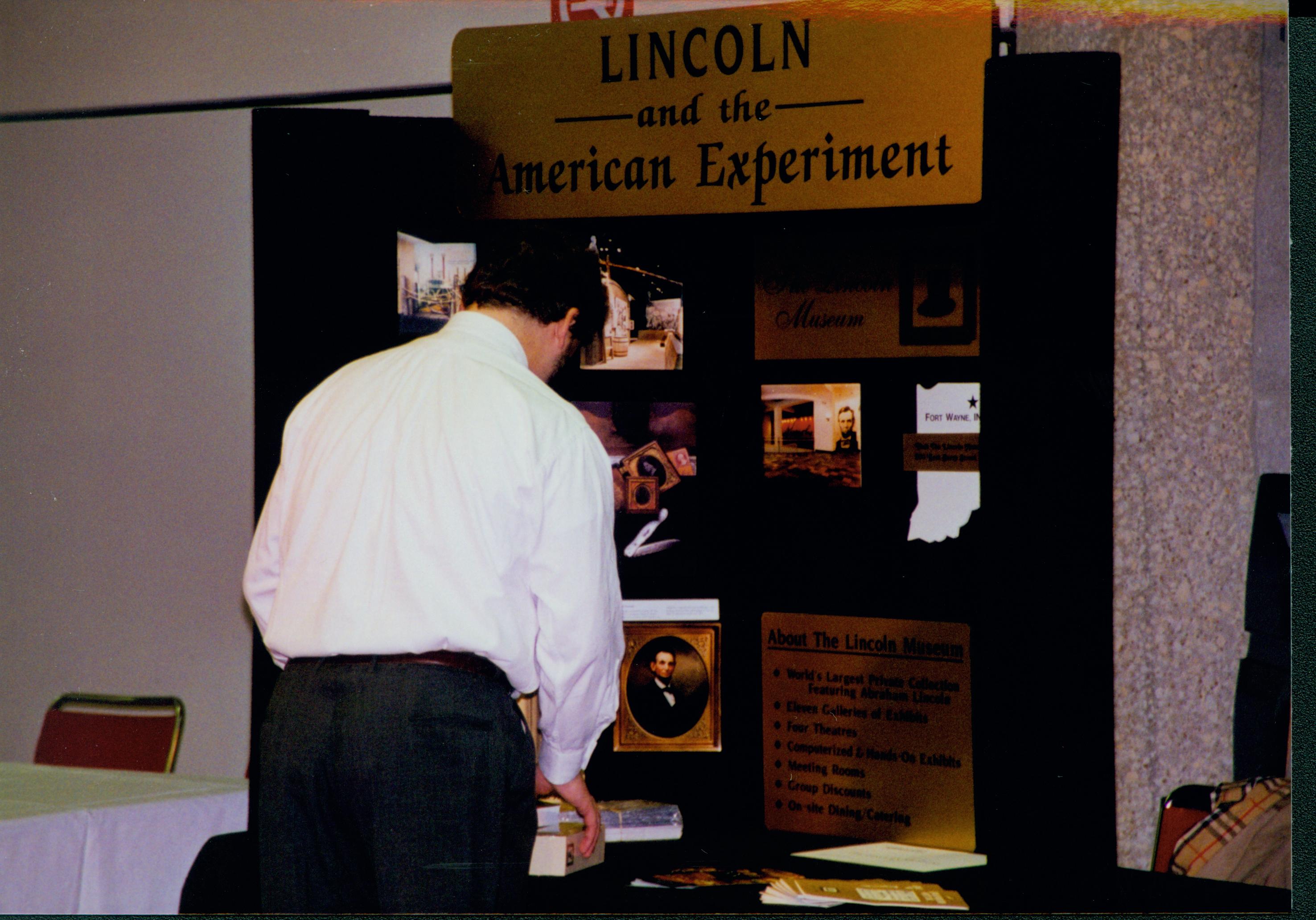 Setting up an exhibit (American Experiment). 5-1997 Colloq (color); 27 Colloquium, 1997