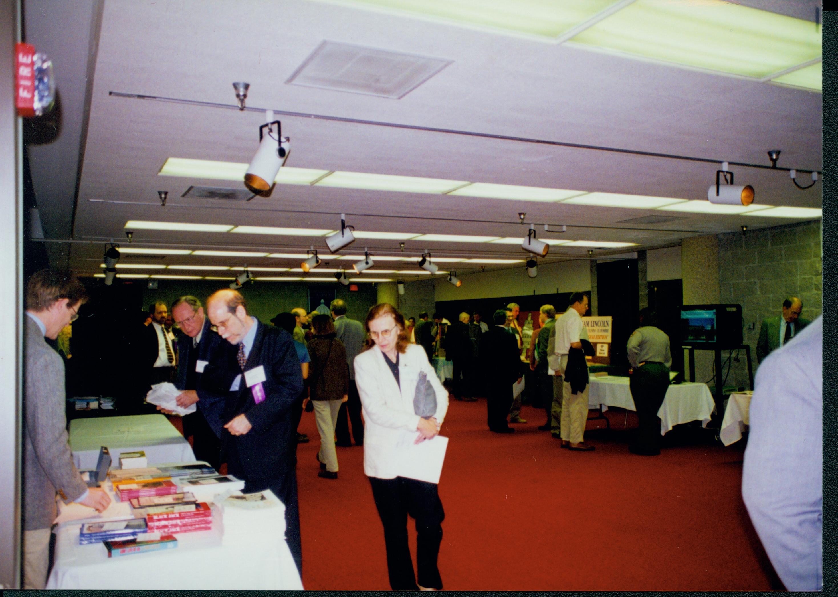 Three people at book table. 1-1997 Colloq (color); 17 Colloquium, 1997