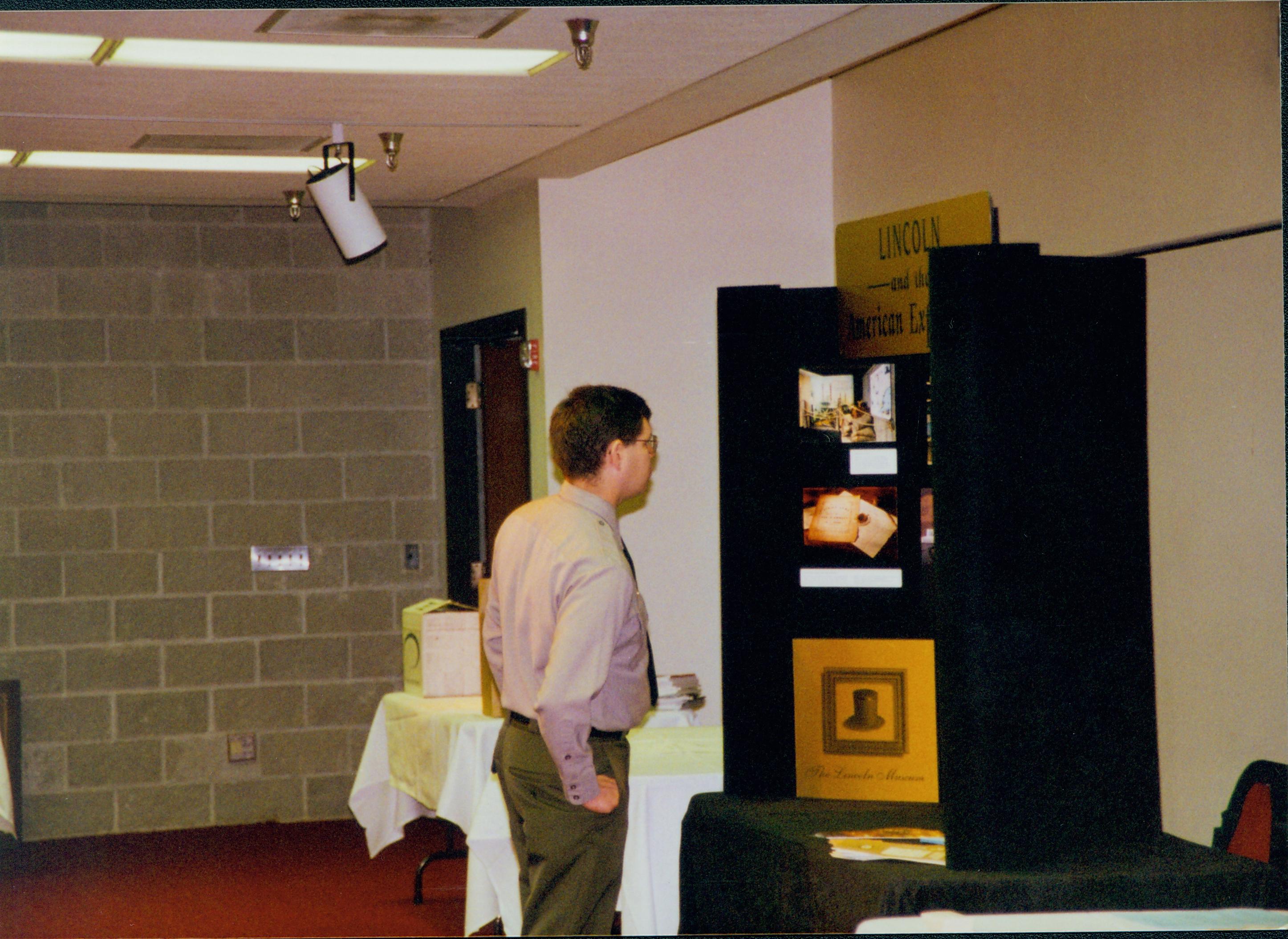 Mike Starasta browsing in exhibits 5-1997 Colloq (color); 36 Colloquium, 1997