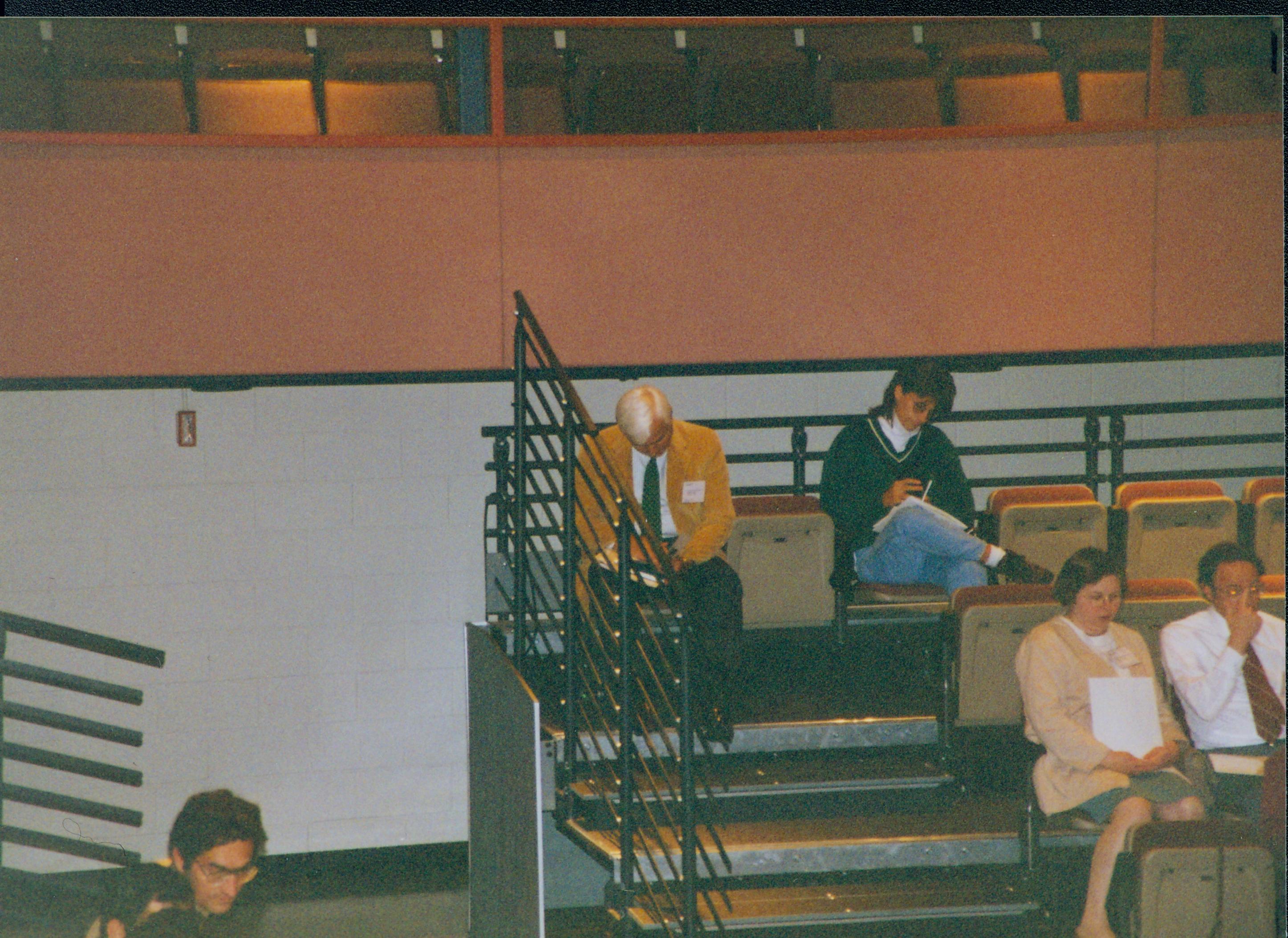 Two men seated top row reading. 1-1997 Colloq (color); 18 Colloquium, 1997