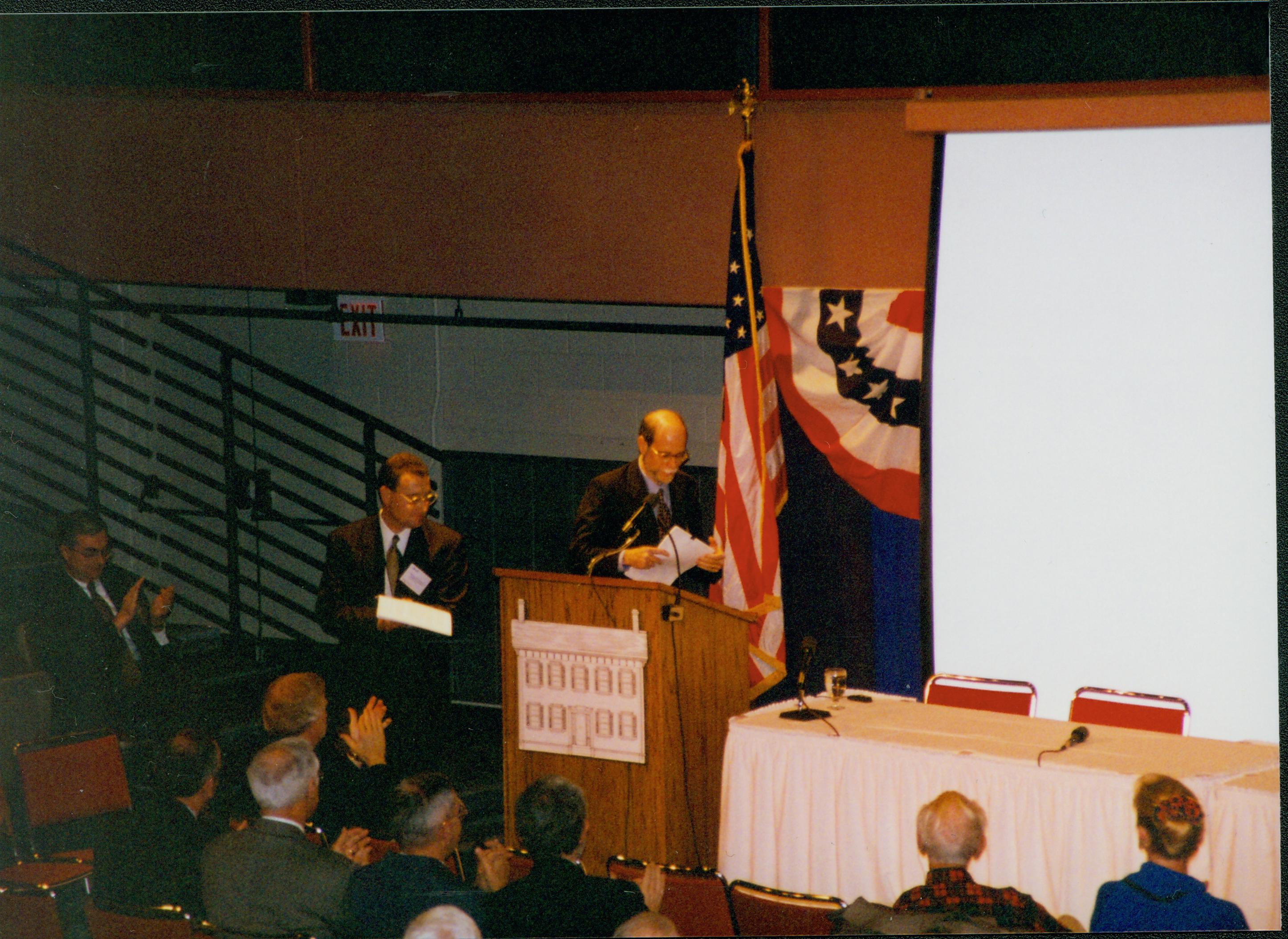 Man stepping to podium 1-1997 Colloq (color); 24 Colloquium, 1997