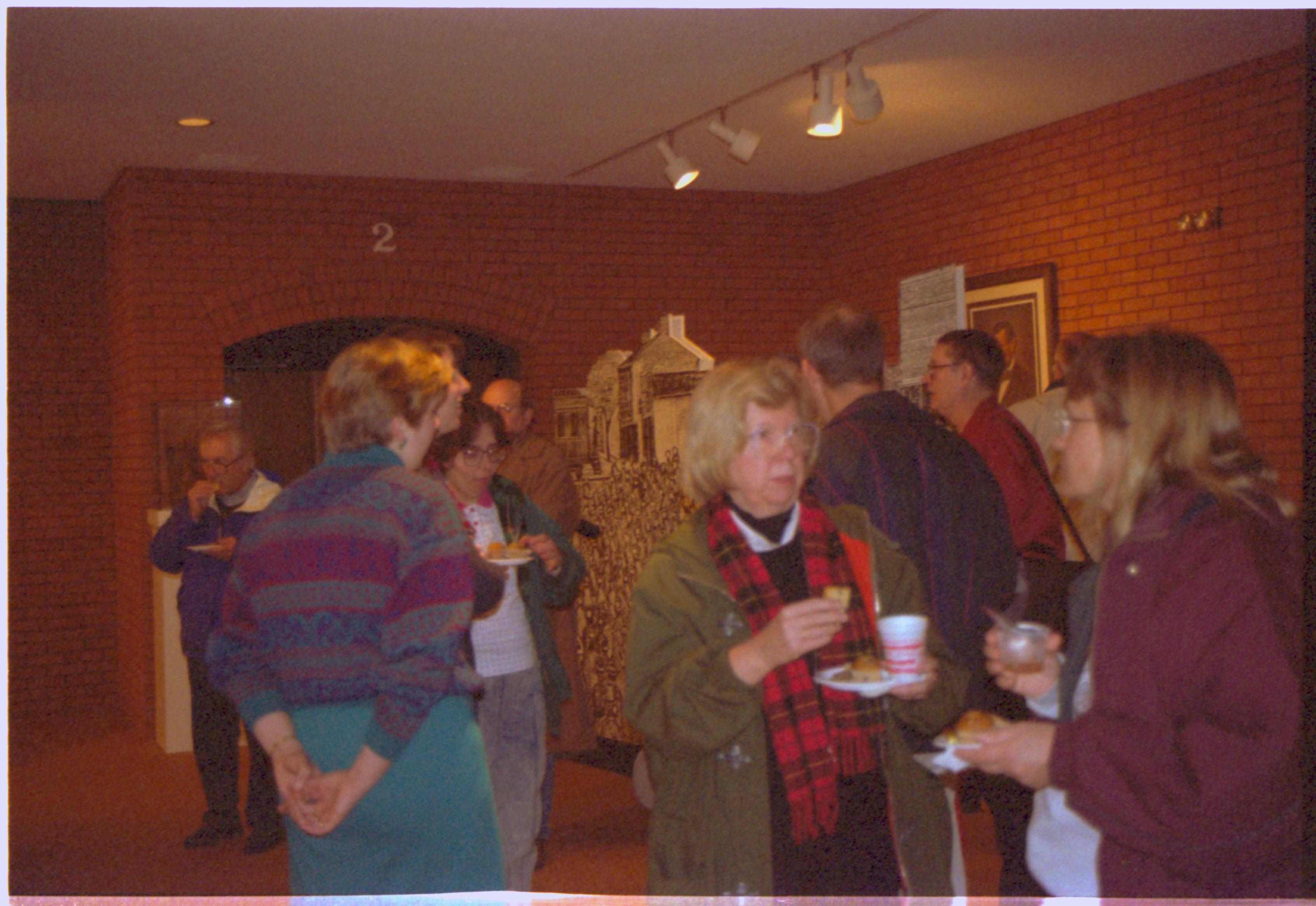 People standing, eating & talking in VC. 2-1997 Colloq (color); 3 Colloquium, 1997