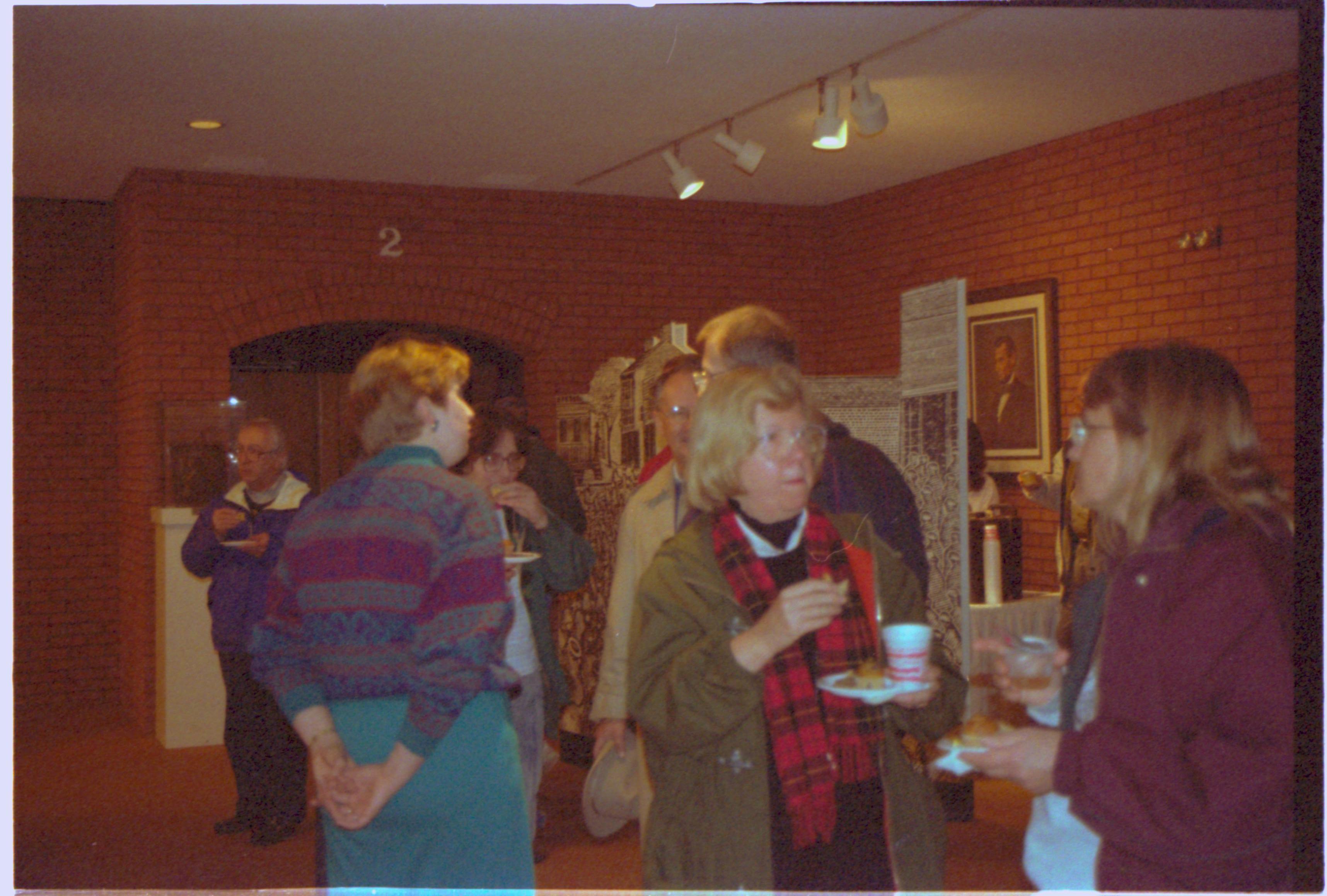 People standing, eating & talking in VC. 2-1997 Colloq (color); 4 Colloquium, 1997