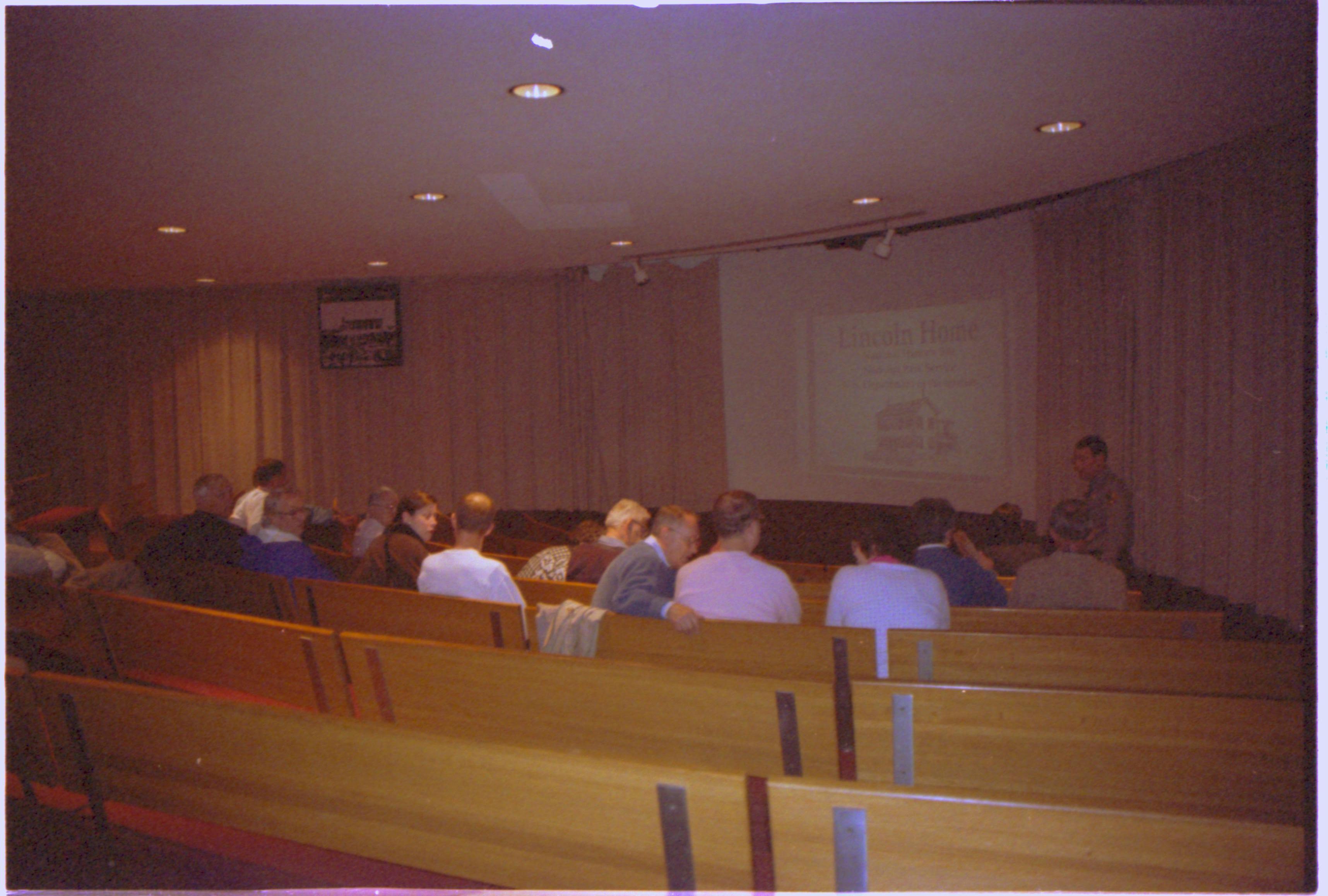 Ranger speaking to visitors in theater I. 2-1997 Colloq (color); 12 Colloquium, 1997