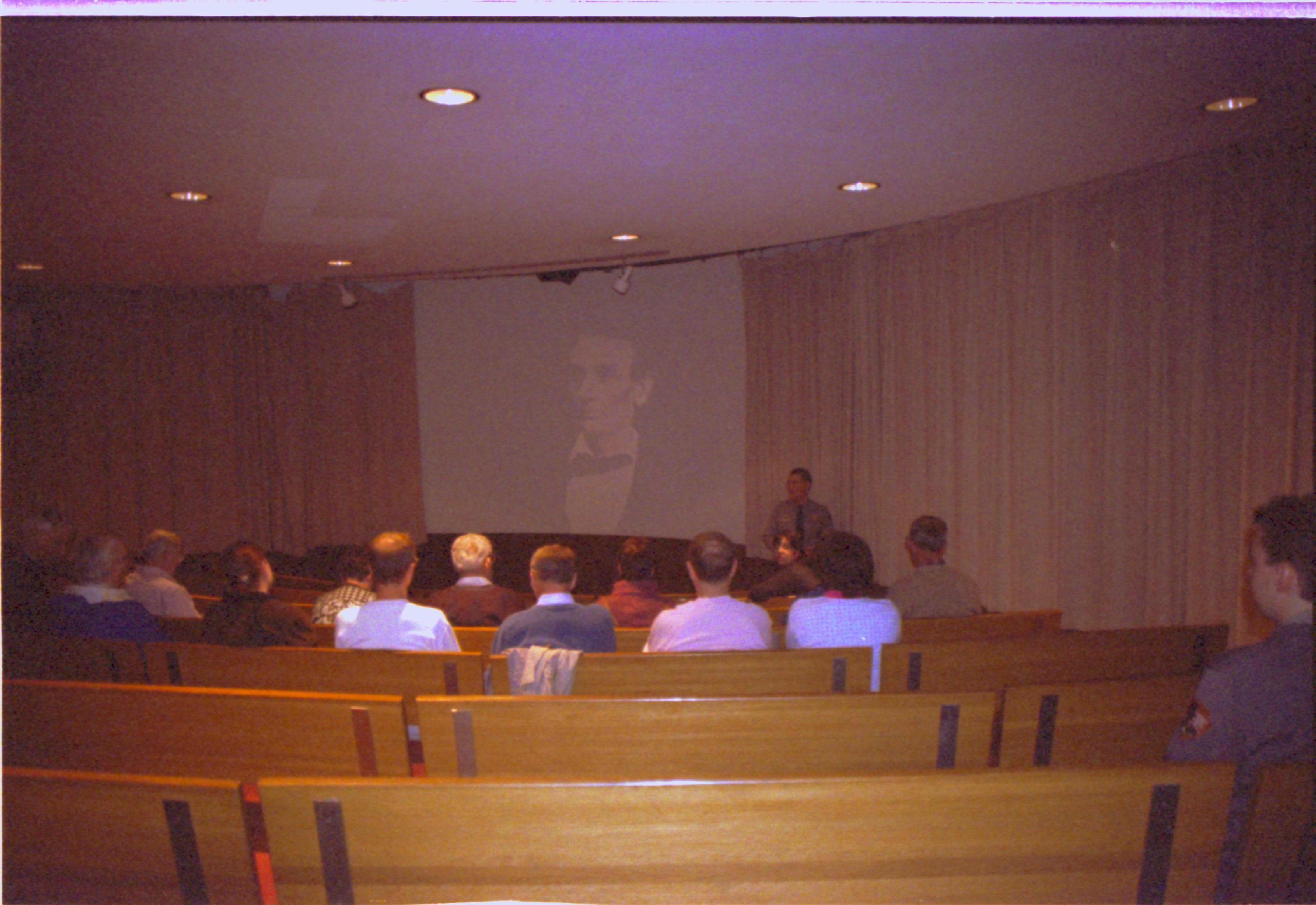 People listening to lecturer. Image on screen. 2-1997 Colloq (color); 15 Colloquium, 1997