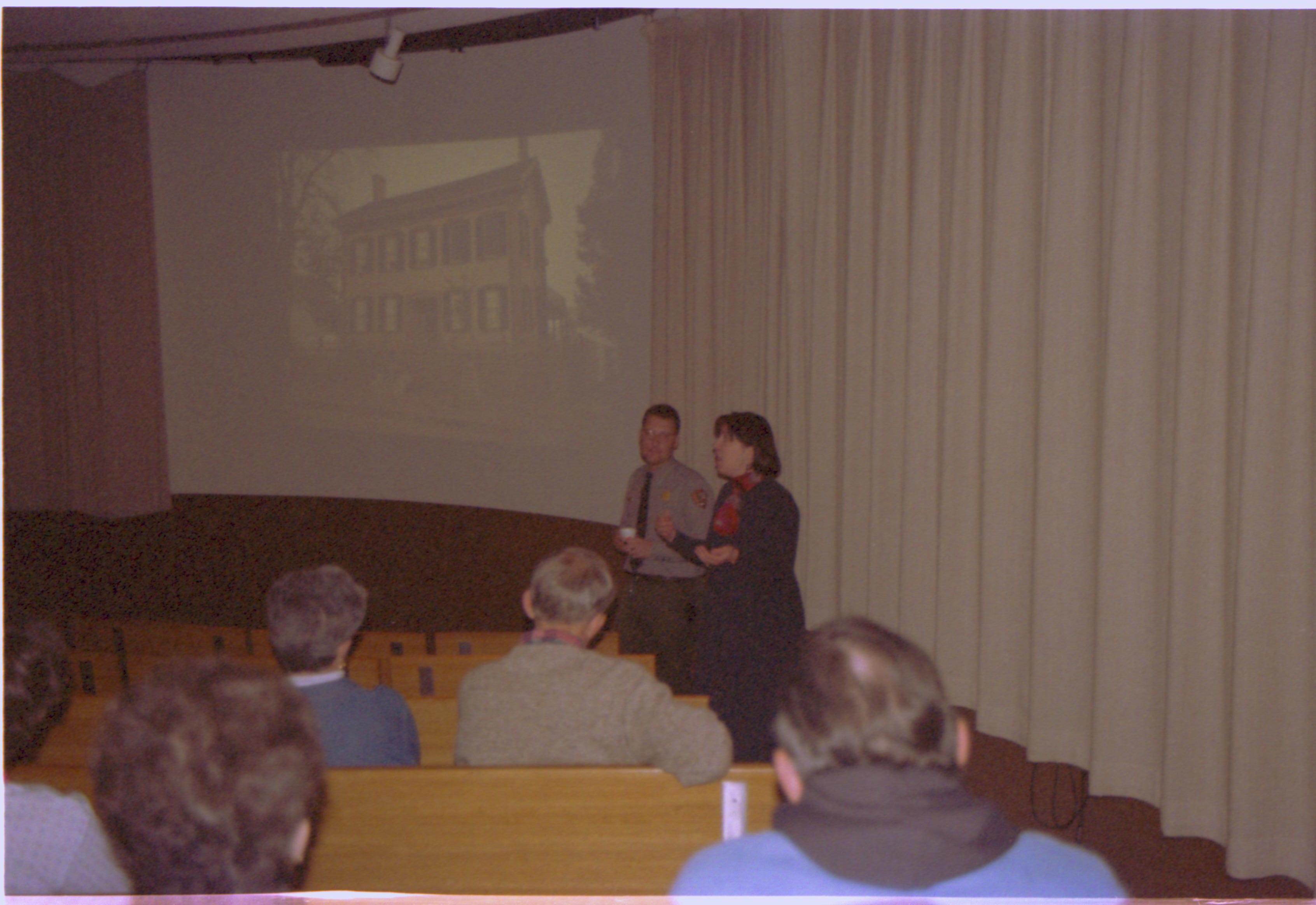 Man and lady talking to audience. 2-1997 Colloq (color); 18 Colloquium, 1997