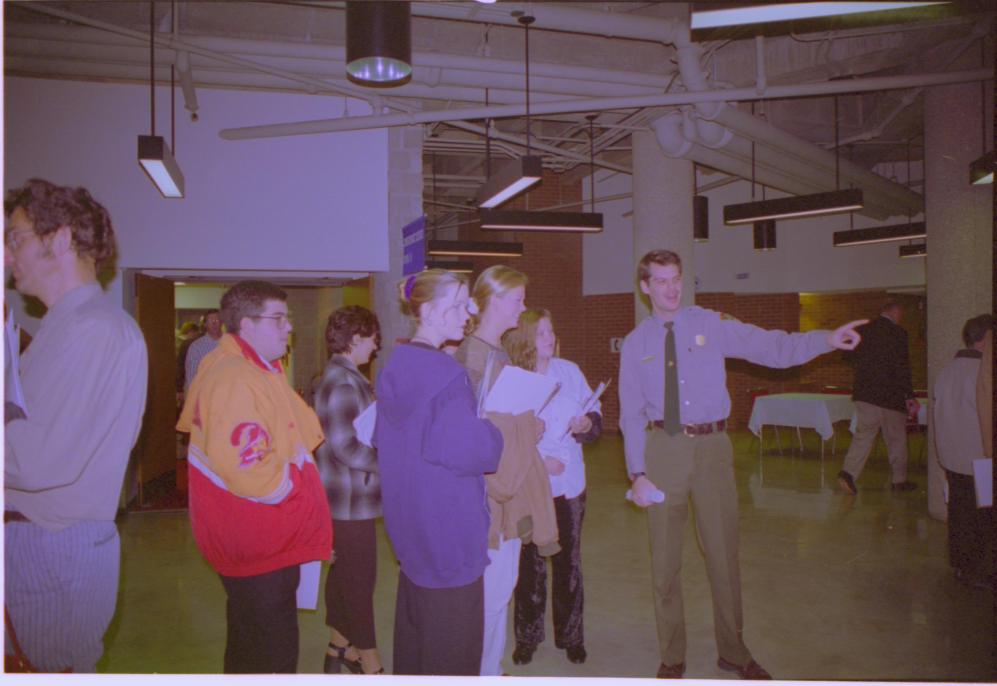 Ranger speaking to HS students in hall. 3-1997 Colloq (color); 8 Colloquium, 1997