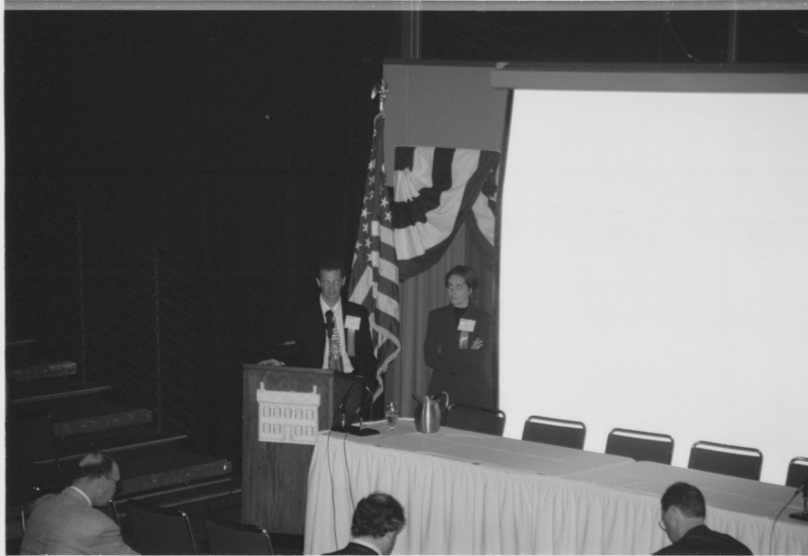 Man and woman at podium. 1999-16; 28 Colloquium, 1999