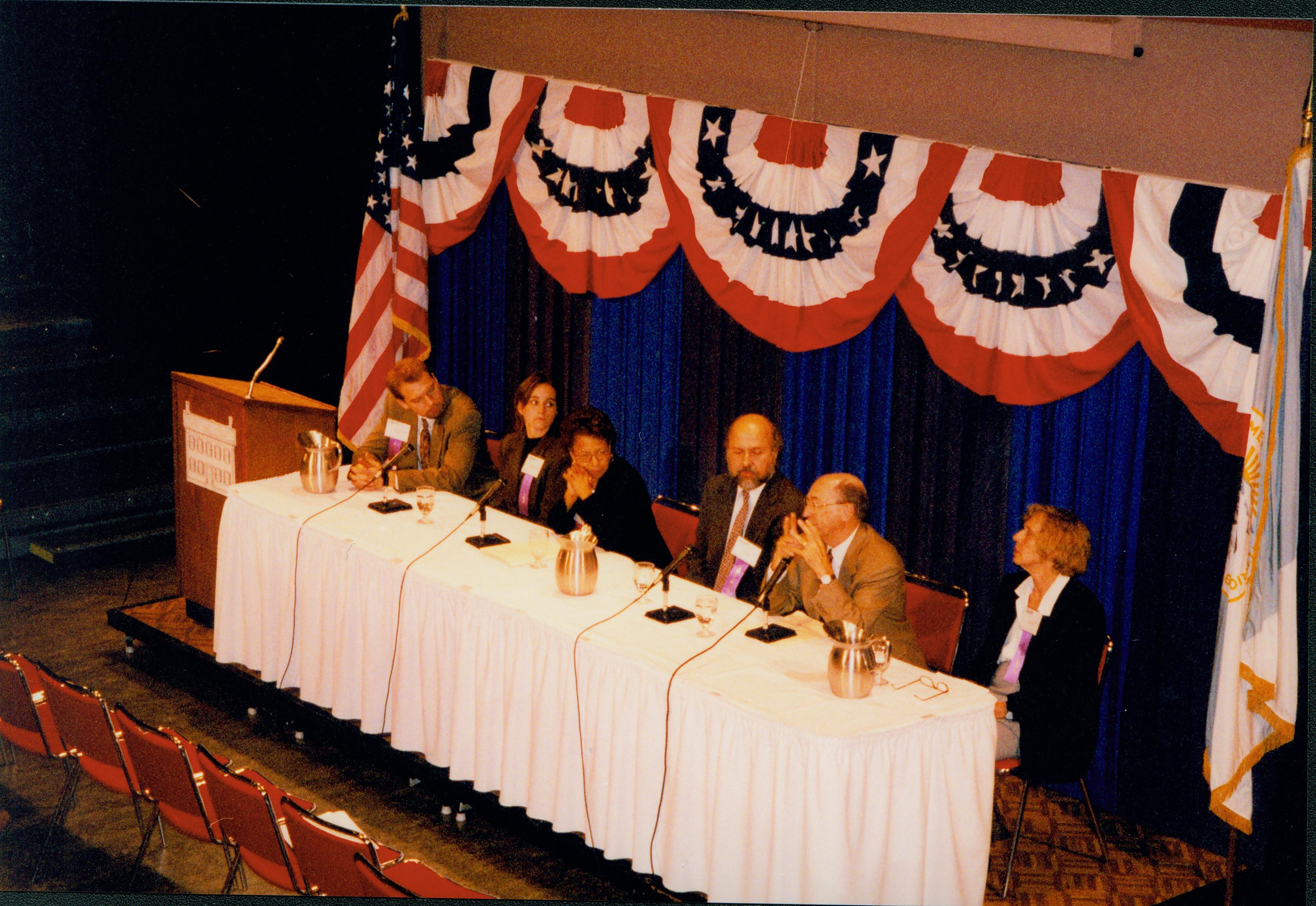 Panel session, seated at table.  1999-12; 11 Colloquium, 1999