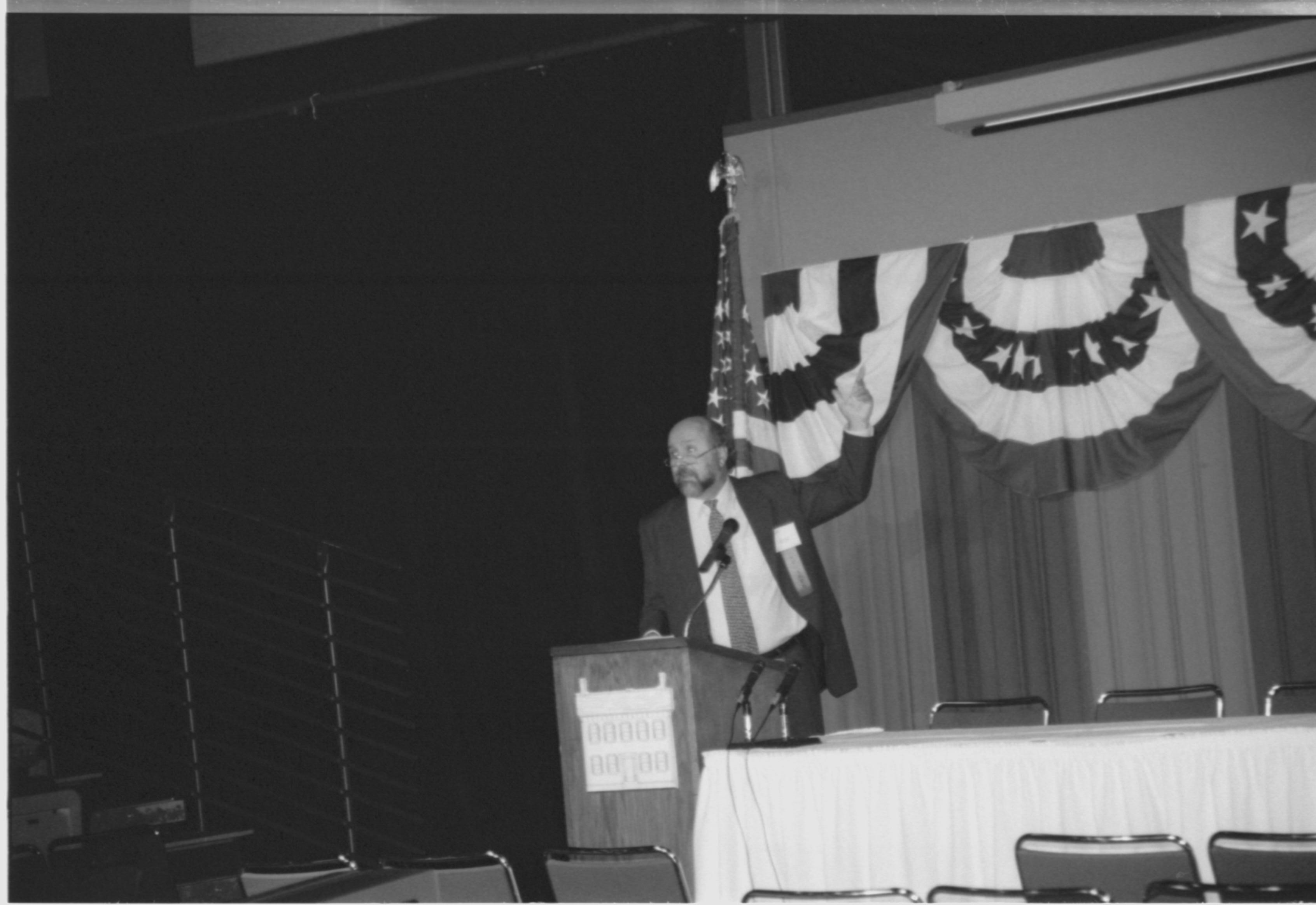 Man speaking at podium. 1999-16; 7 Colloquium, 1999