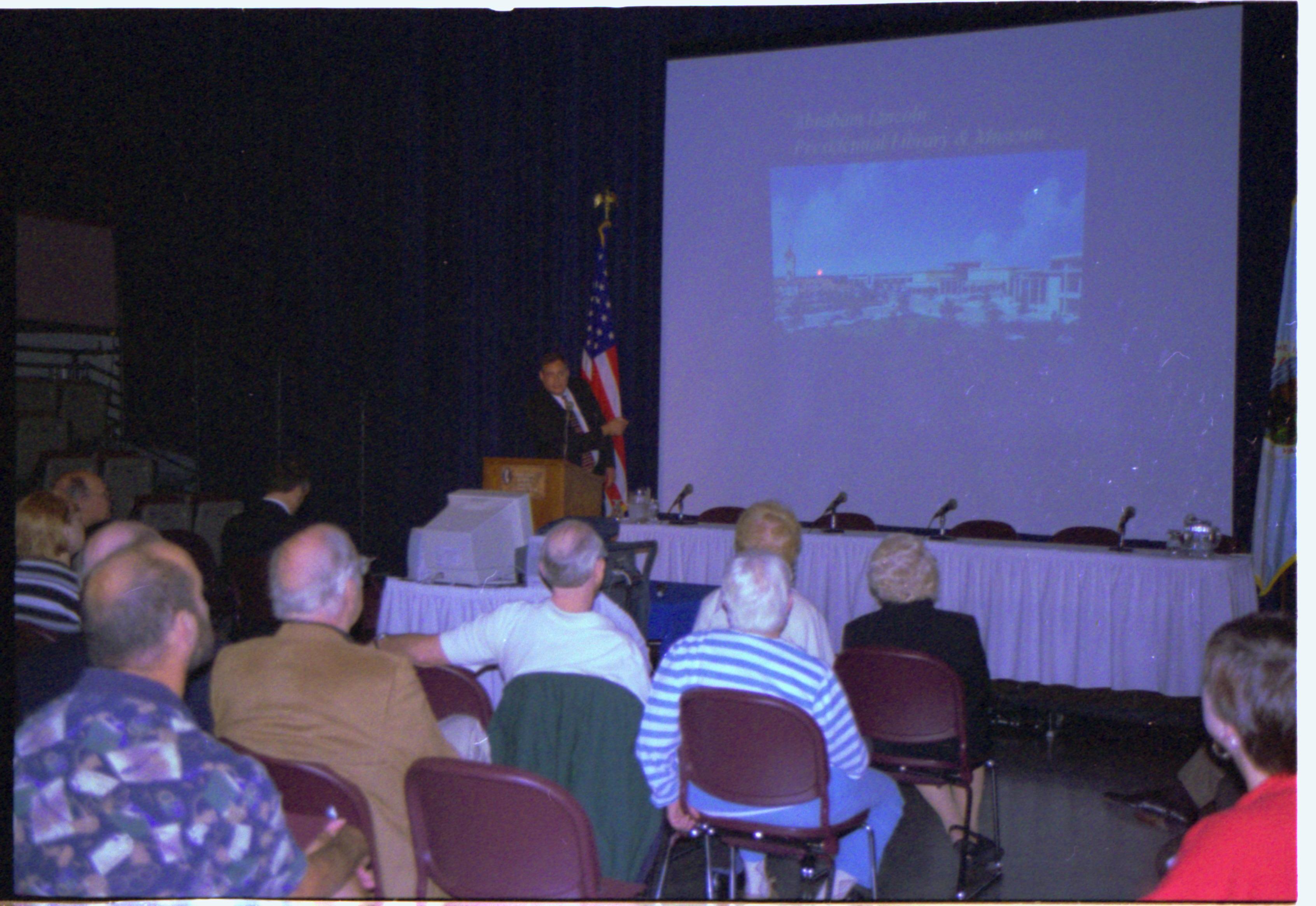 Speaker showing slides on screen. Colloquium, 2001