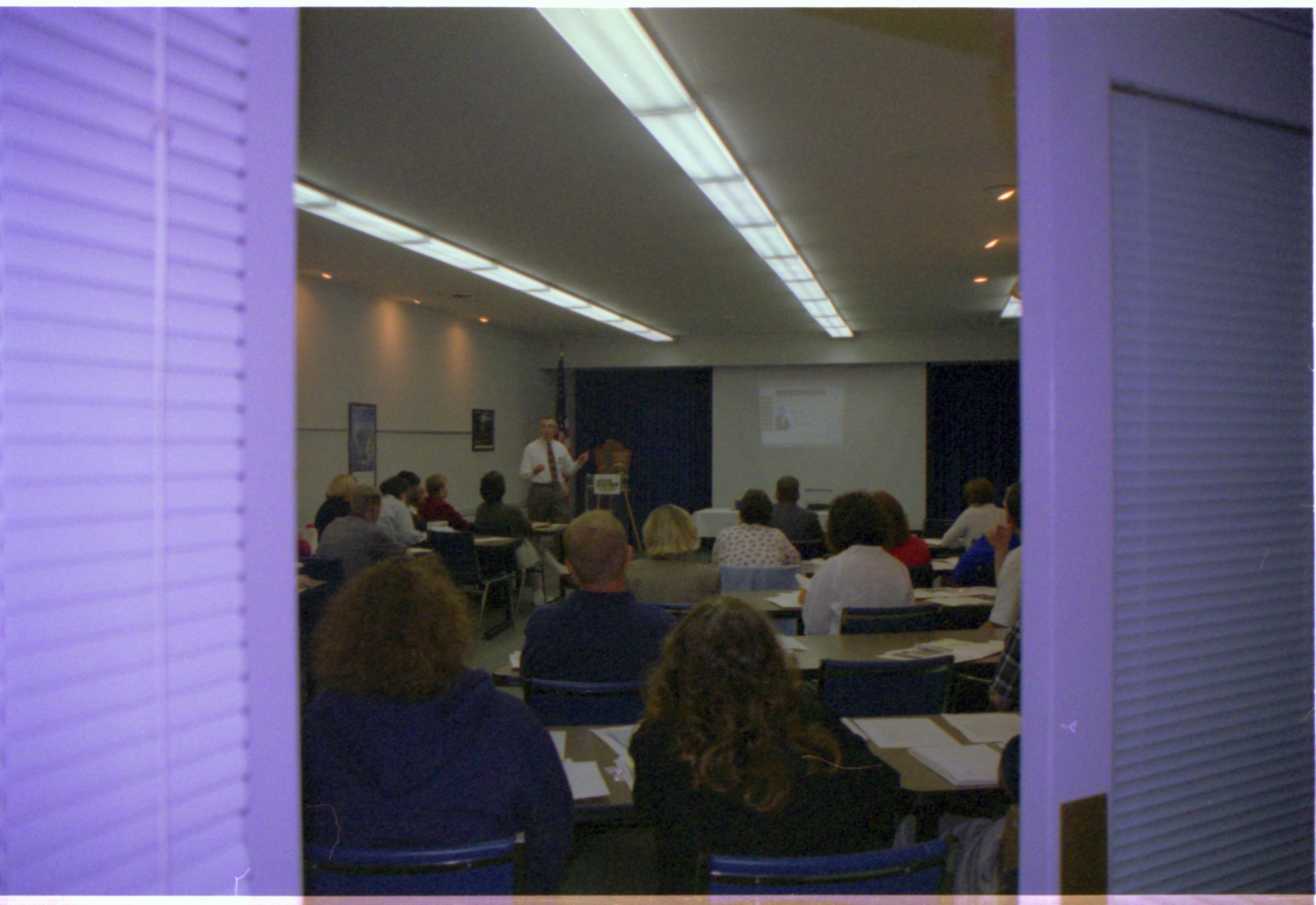 Class room with students and presenter. 