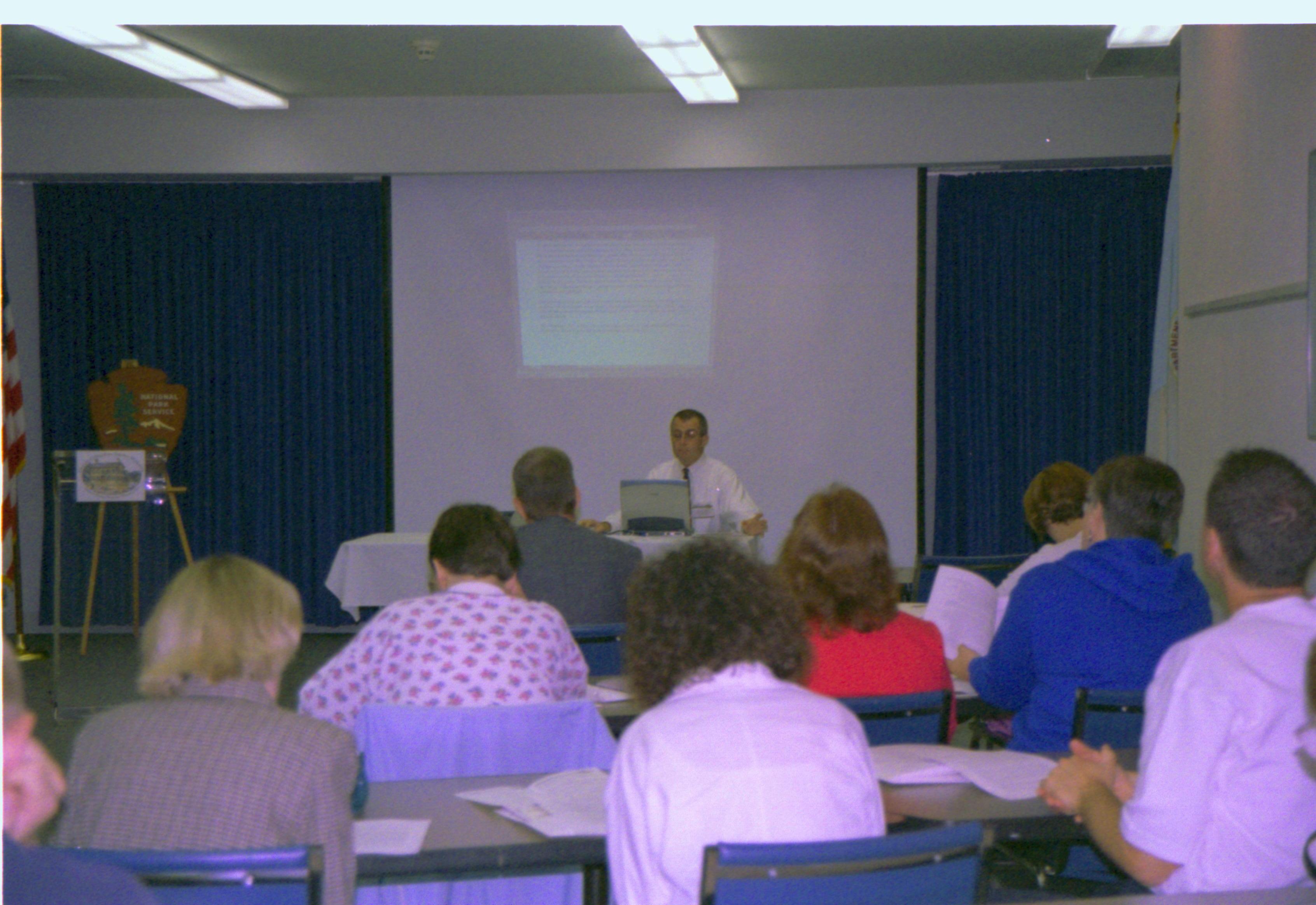 Class room with students and presenter. 