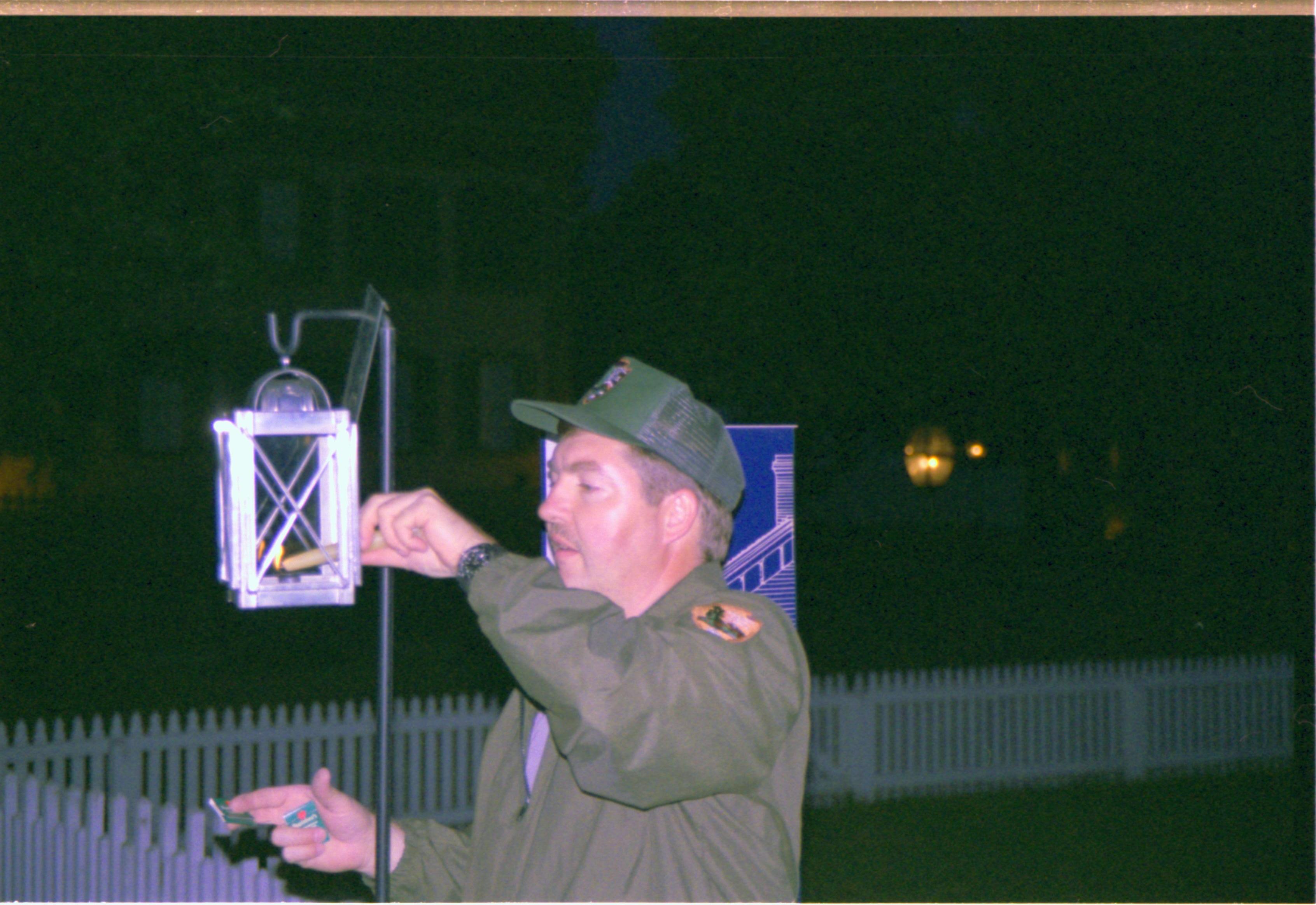 Man lighting lantern. Candle lighting
