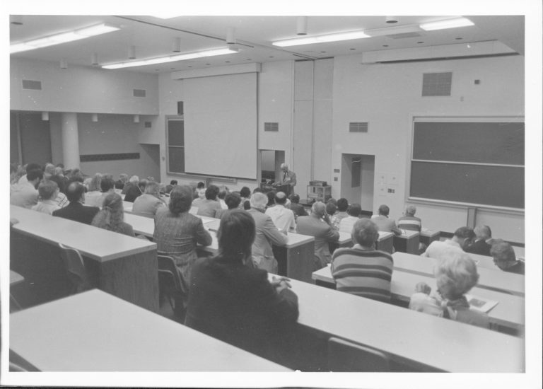 Speaker in large lecture room. Lincoln, Colloquium