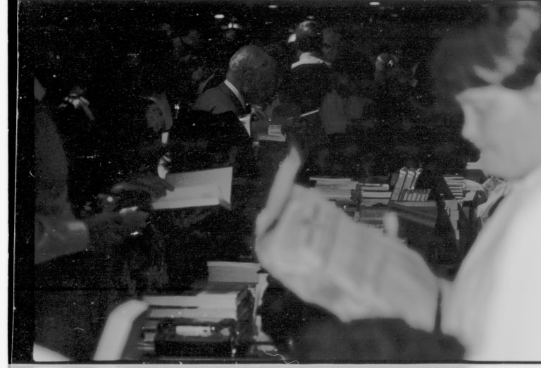Visitors looking at books. Colloquium, 1991 Lincoln, Colloquium