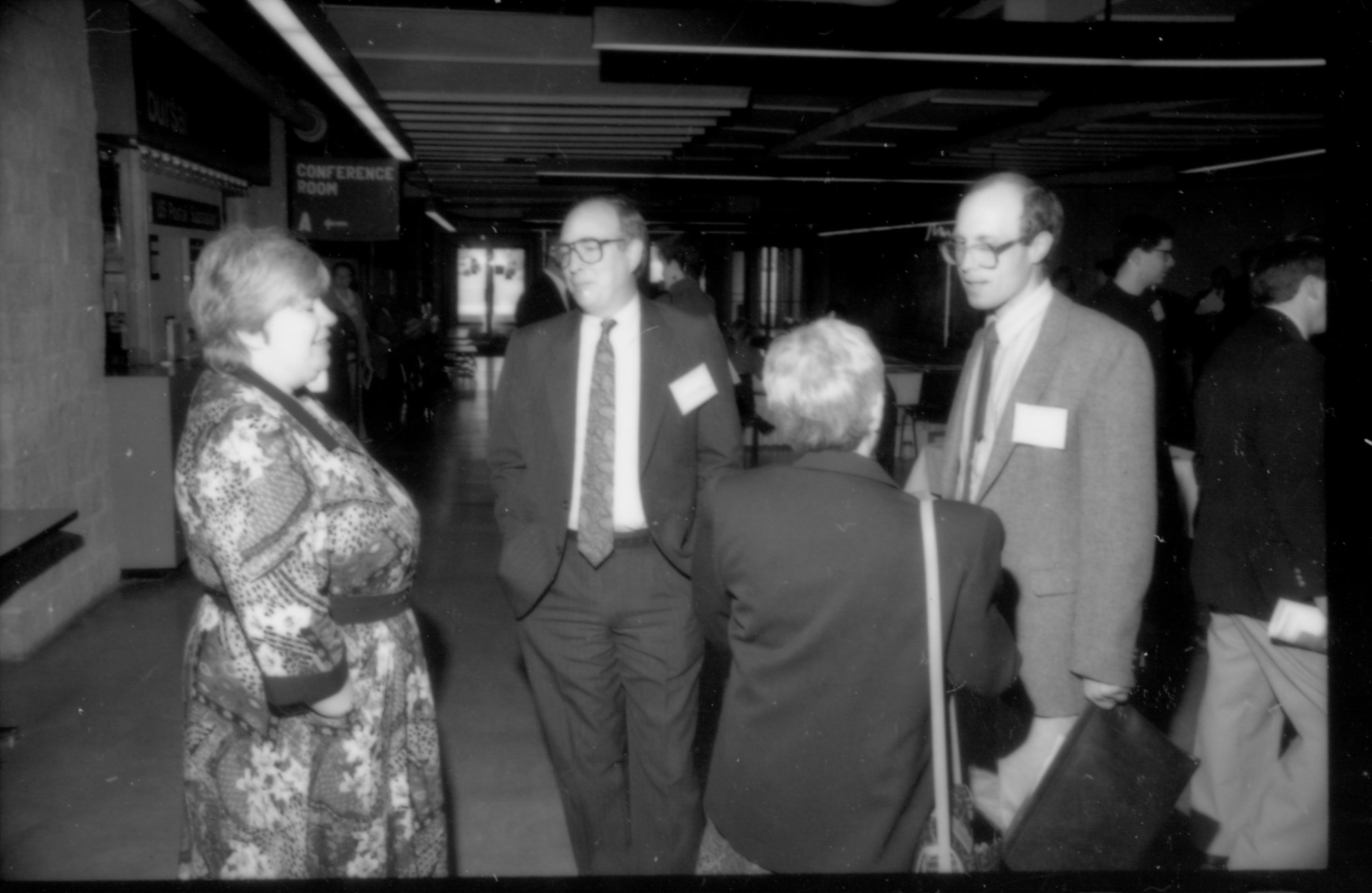 Two women and two men talking to one another. 1992 Lincoln Colloquium; Outside #72 Lincoln, Colloquium