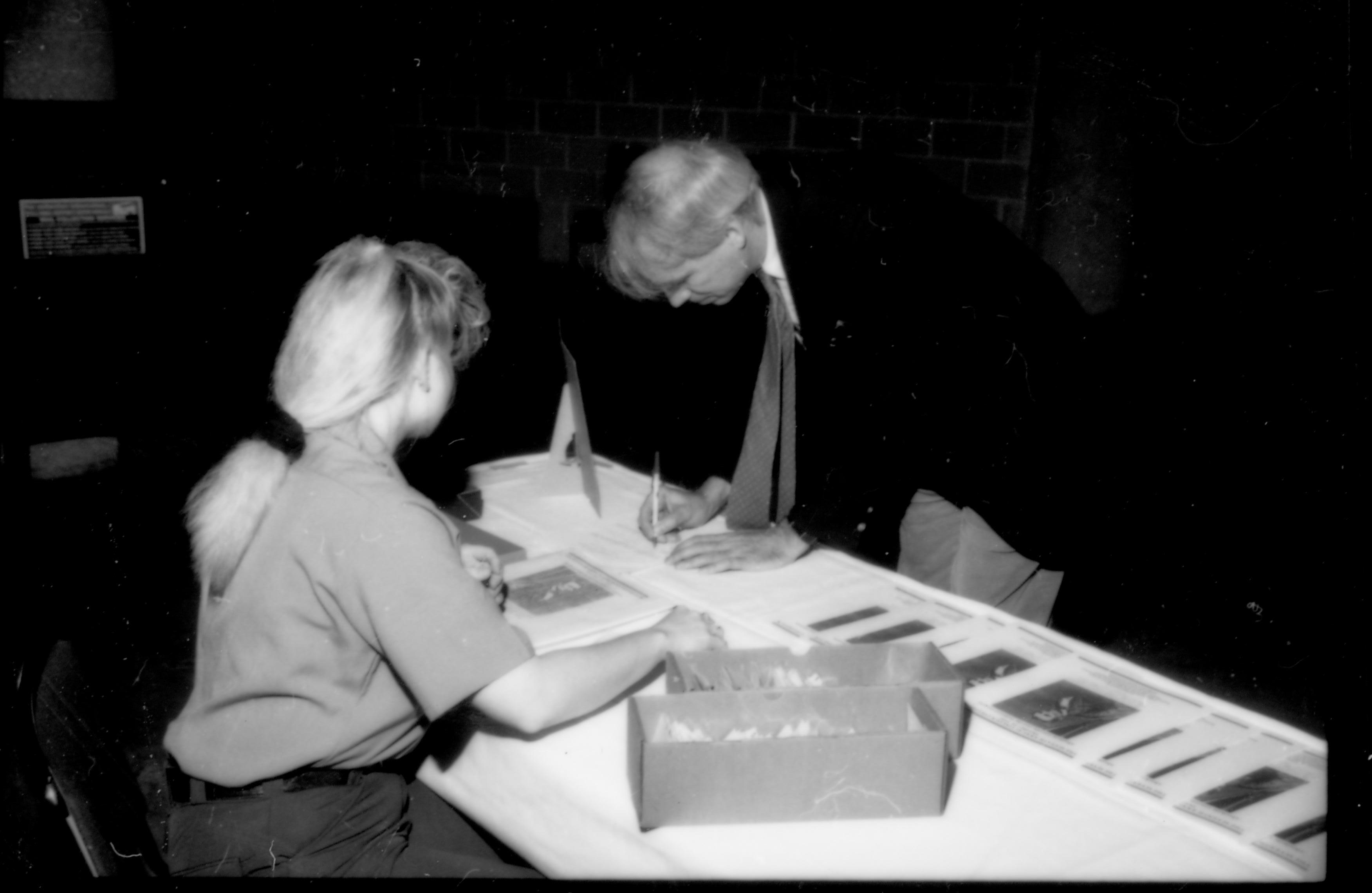 Man signing in at table. 1992 Lincoln Colloquium; Outside #71 Lincoln, Colloquium