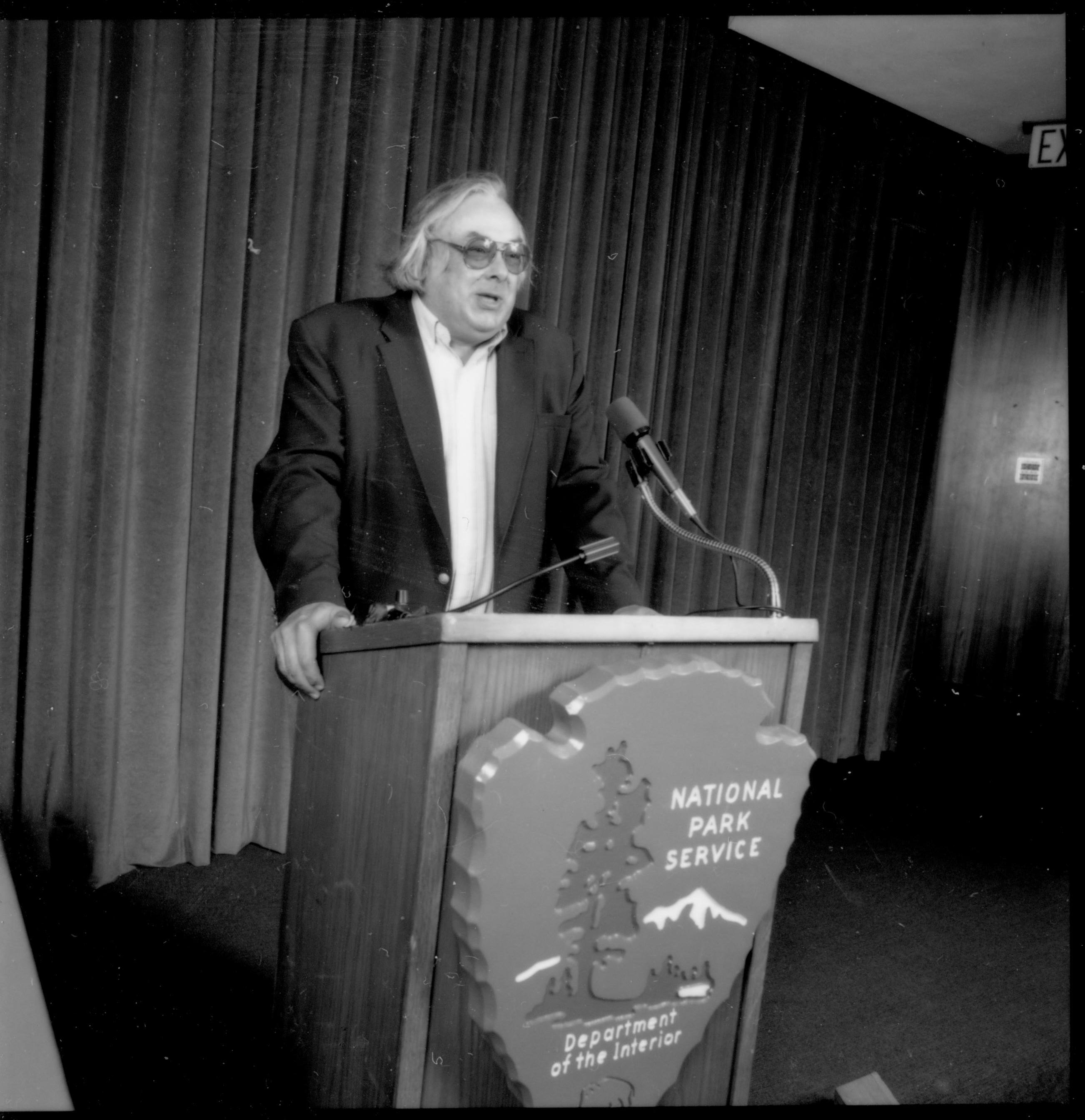 Man (with no tie) speaking at podium. 1992 Lincoln Colloquium; Outside #69 Lincoln, Colloquium