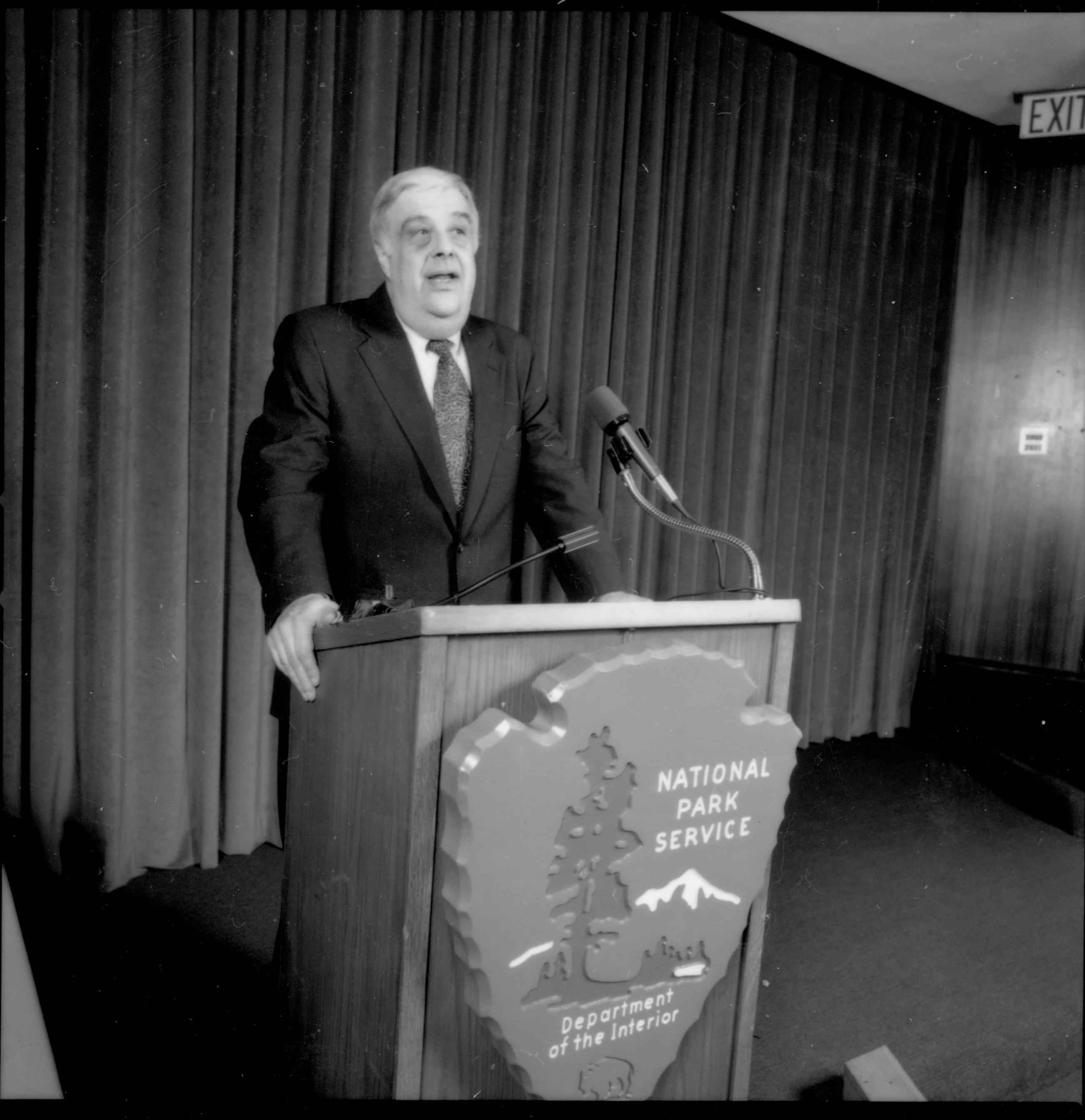 Man at podium with curtain behind him. 1992 Lincoln Colloquium; Outside #69 Lincoln, Colloquium