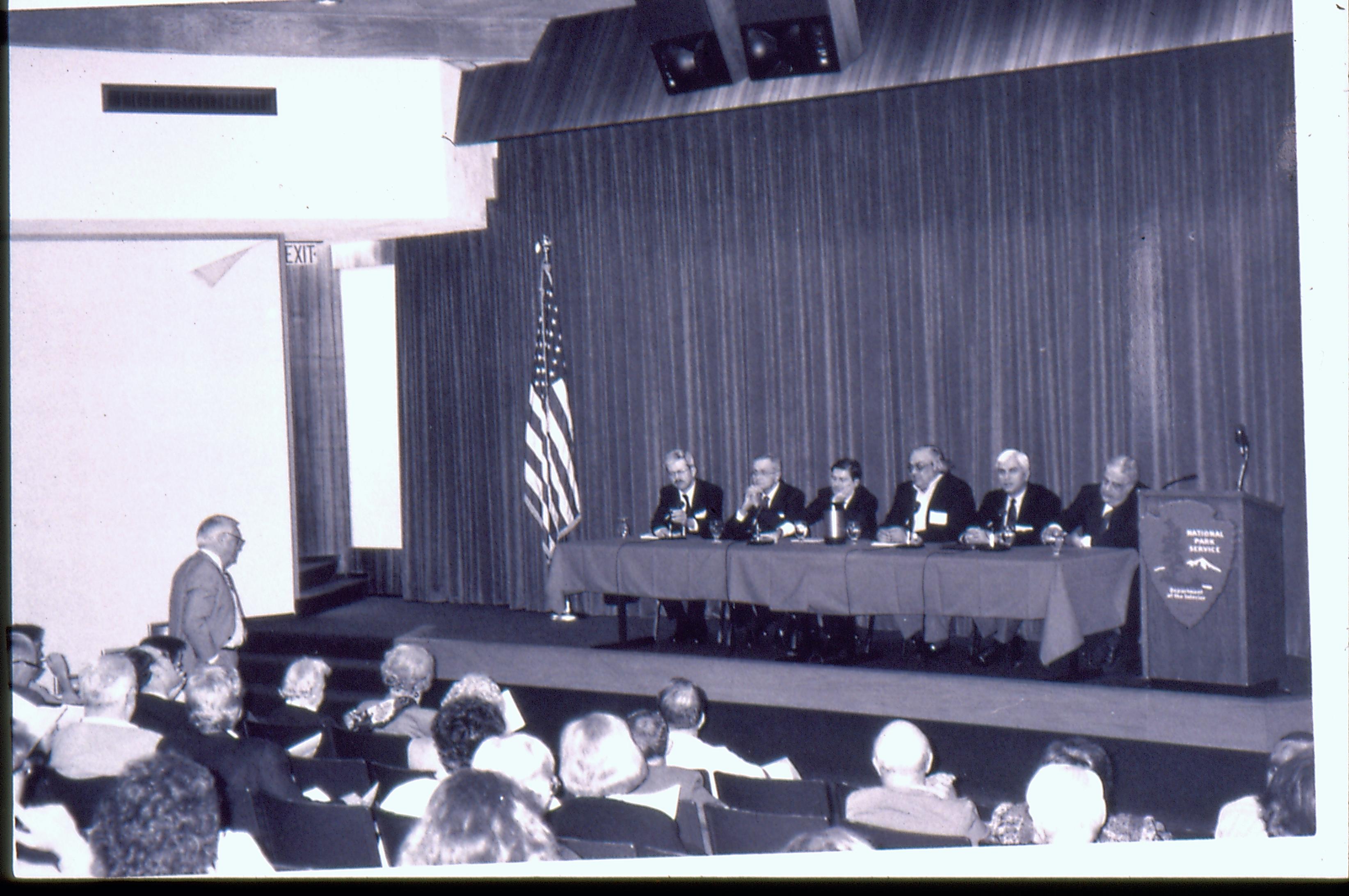 Man addressing speakers table. 1992 Lincoln Colloquium Lincoln, Colloquium