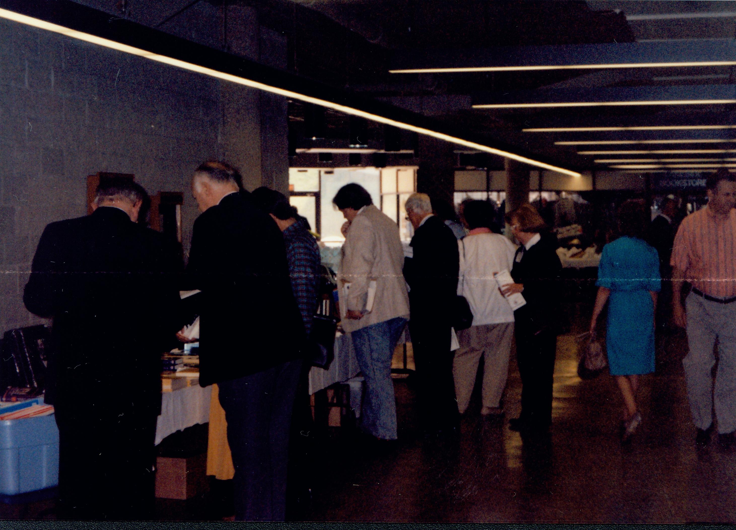 People at book tables in hallway. 1992 Lincoln Colloquium Lincoln, Colloquium