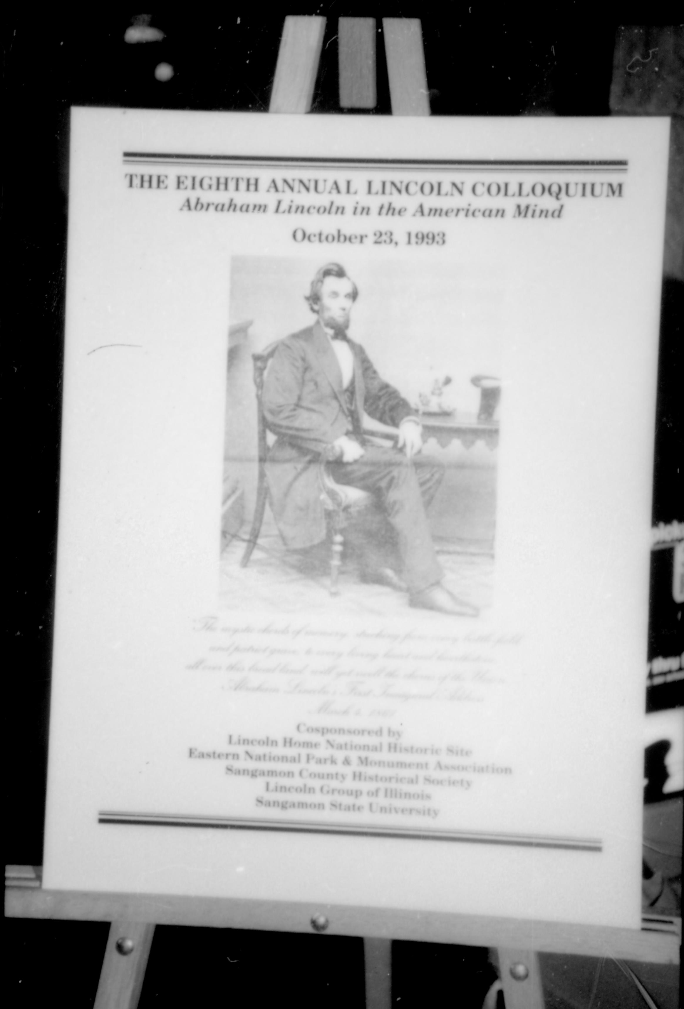 Lincoln sitting, front cover of booklet. 8th Annual Lincoln Colloquium; A Lincoln, Colloquium