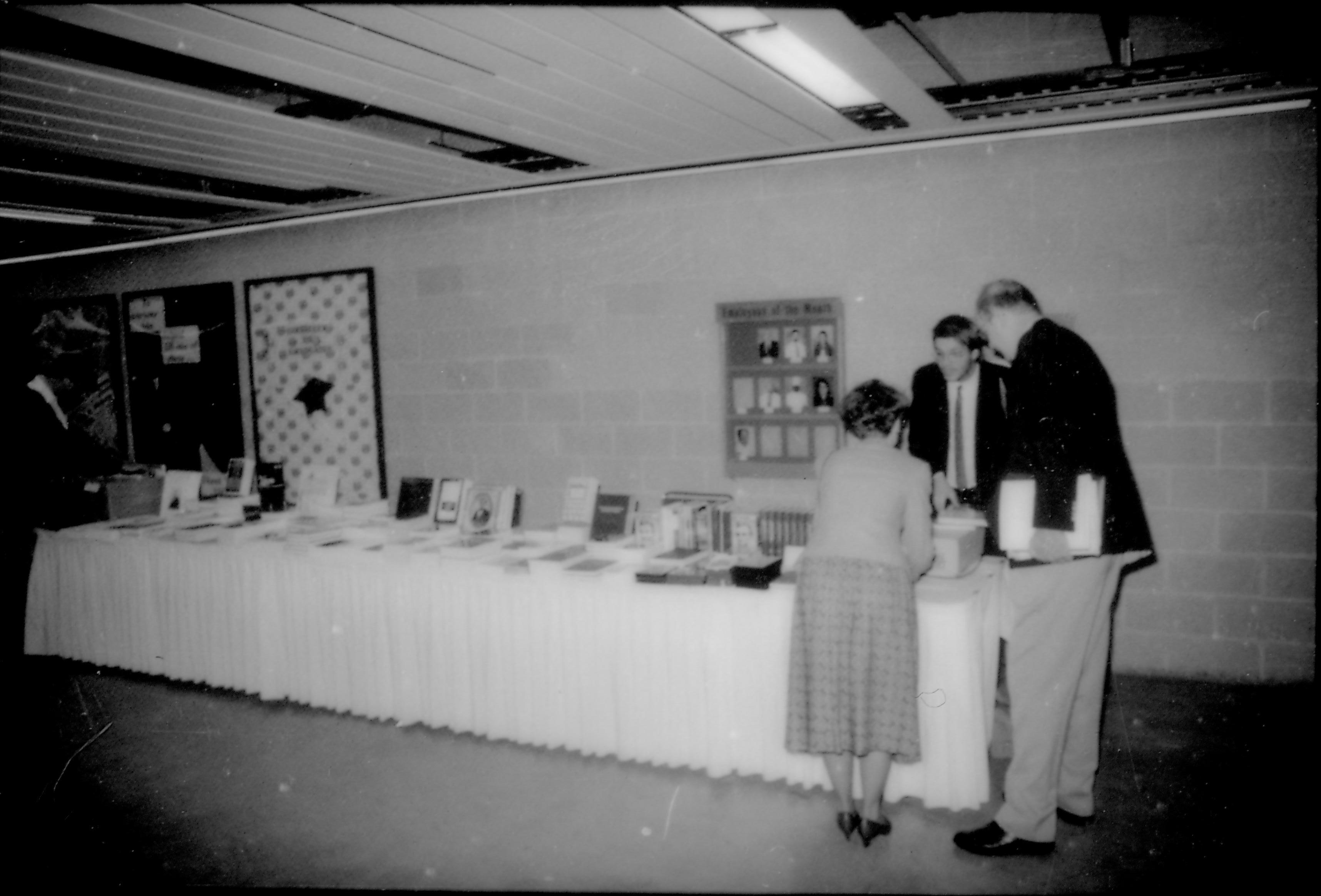 Book table with three customers. 8th Annual Lincoln Colloquium; B Lincoln, Colloquium