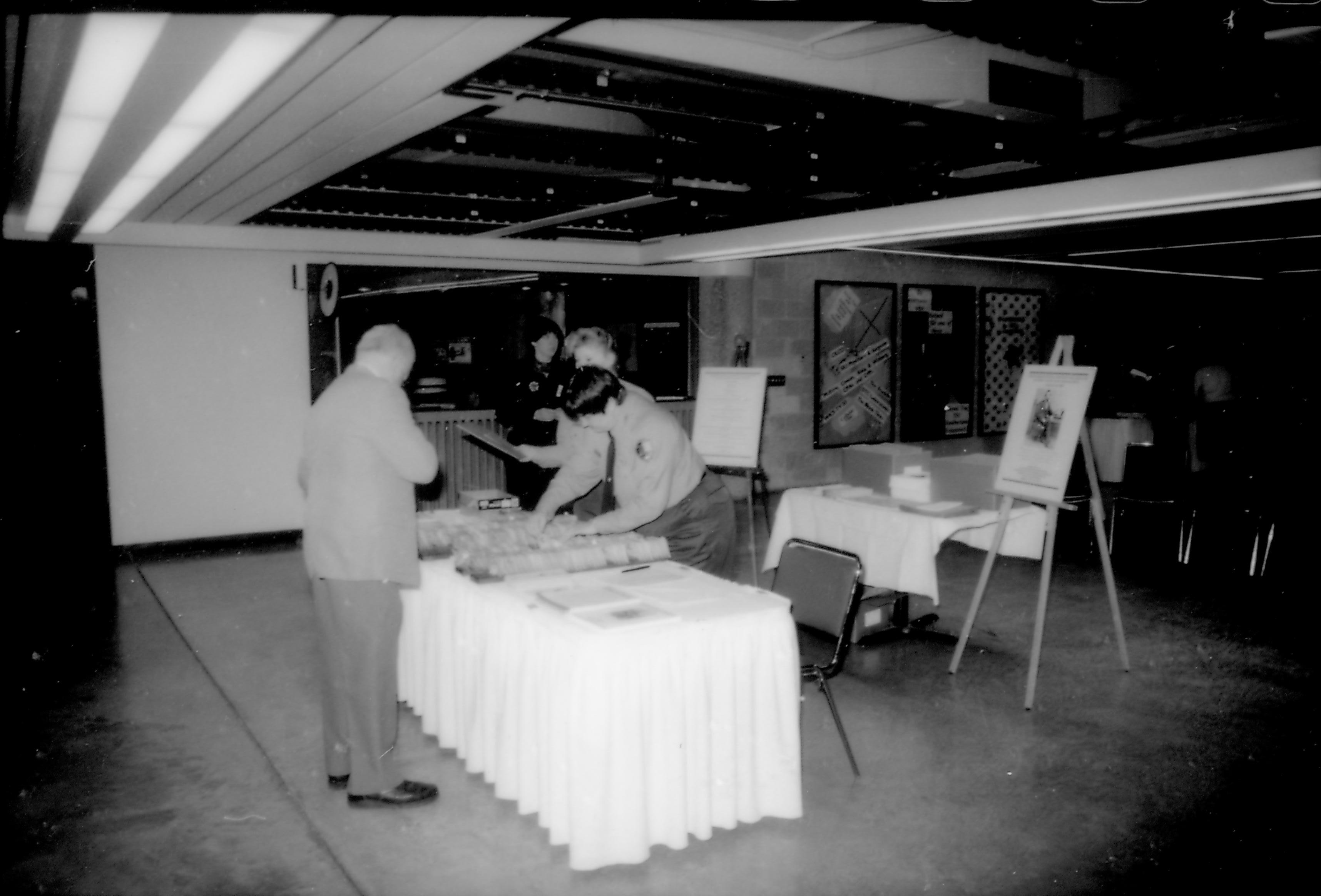 Man at registration table. 8th Annual Lincoln Colloquium; B Lincoln, Colloquium