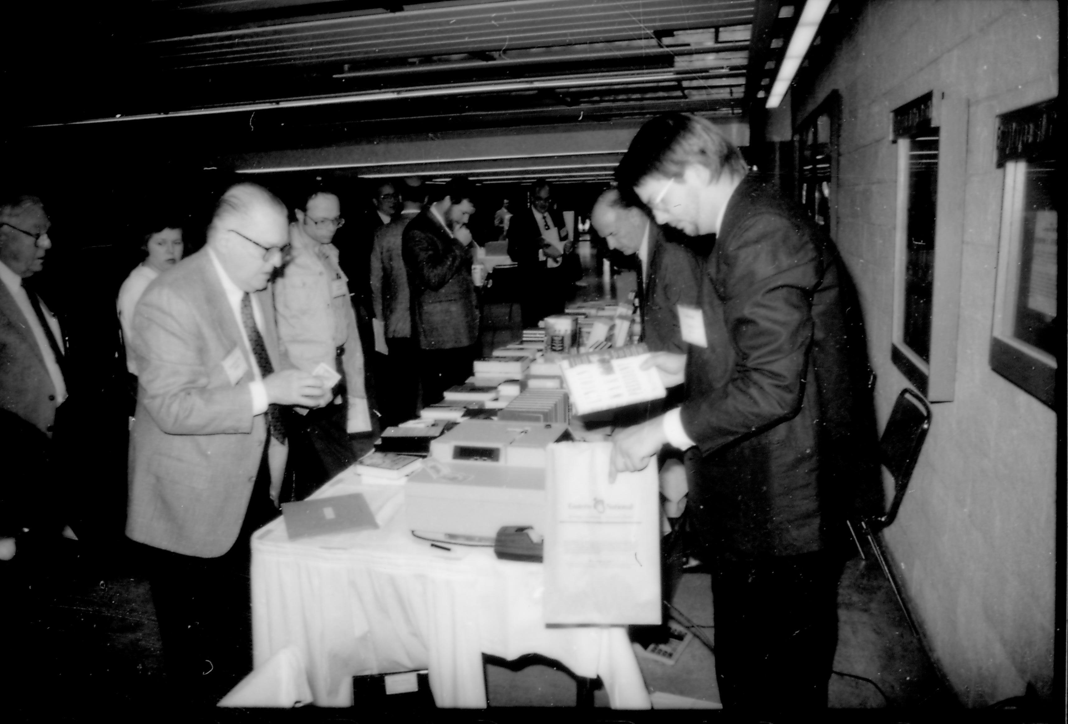 People at book table. 8th Annual Lincoln Colloquium; B Lincoln, Colloquium