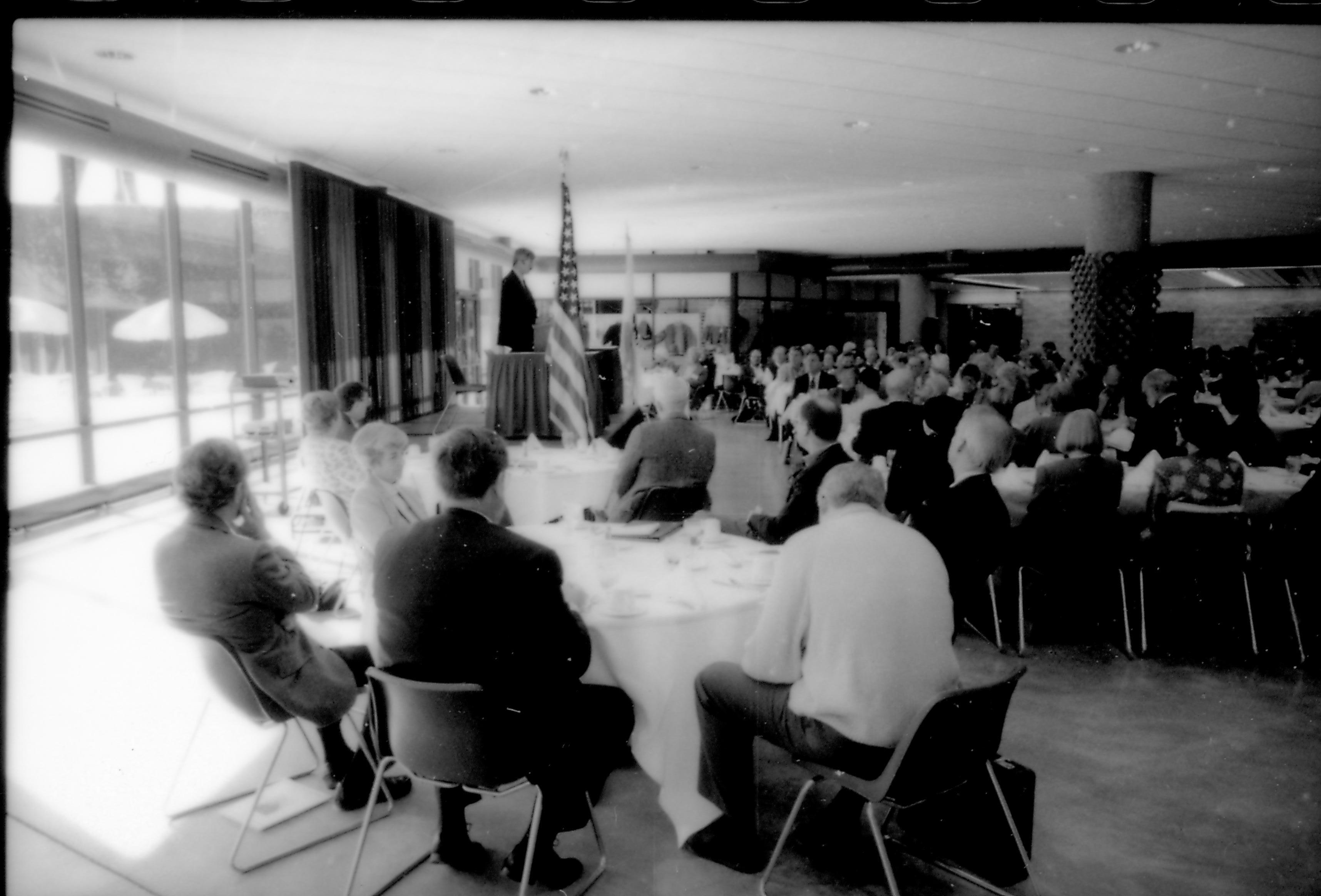 People in dining area (off to the side), listening to speaker. 8th Annual Lincoln Colloquium; B Lincoln, Colloquium