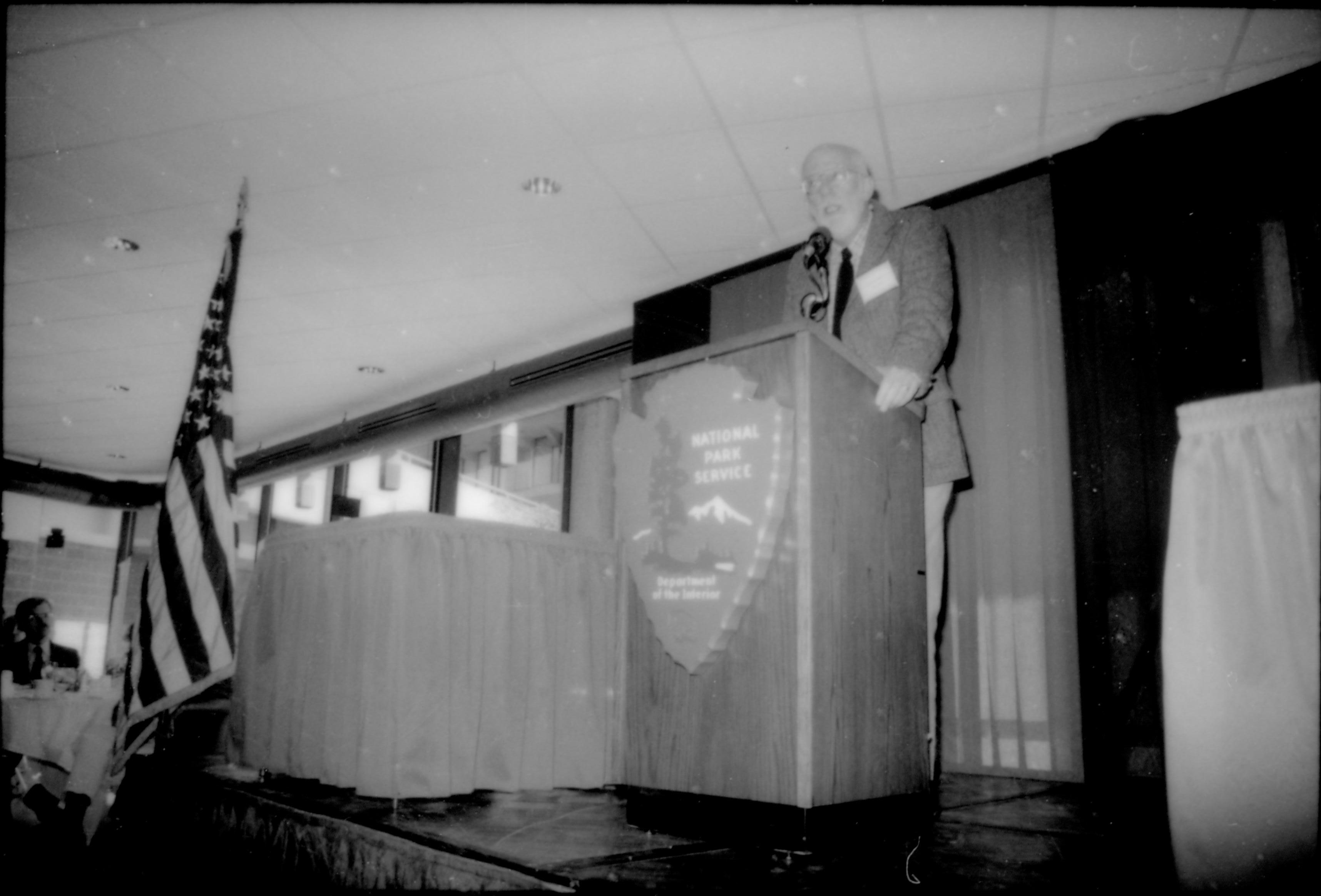 Man speaking at podium. 8th Annual Lincoln Colloquium; B Lincoln, Colloquium