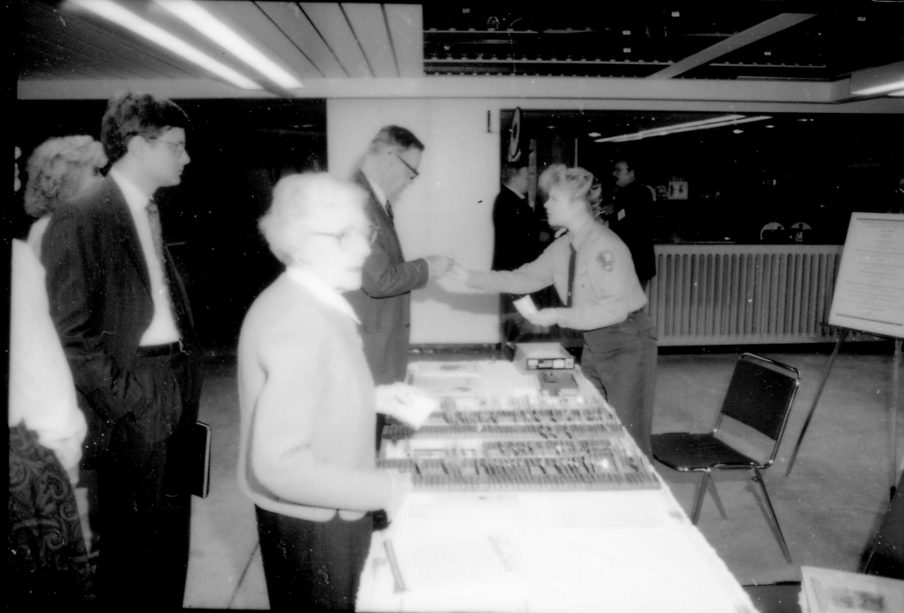 People at registration table. 8th Annual Lincoln Colloquium; A Lincoln, Colloquium