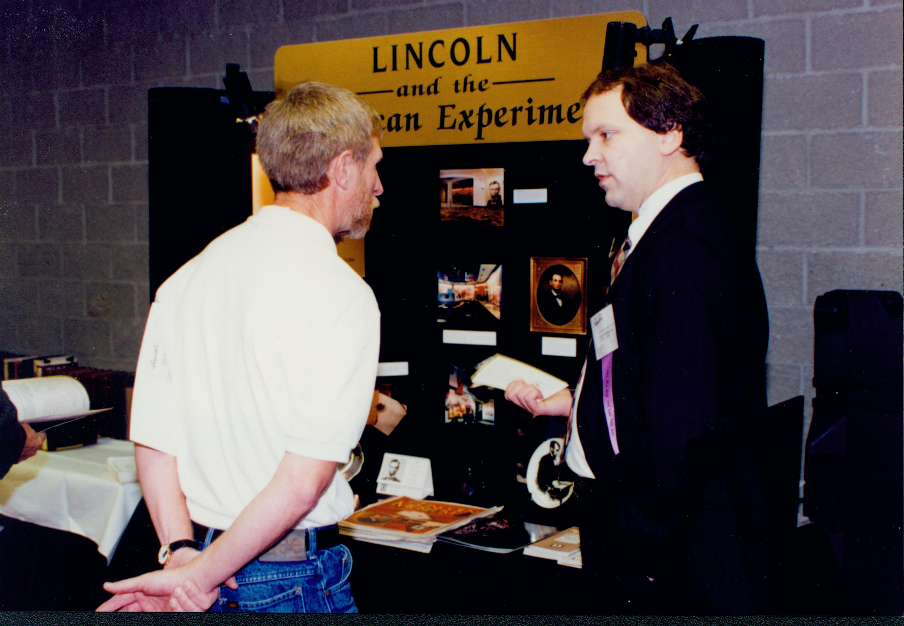 Two men talking in front of exhibit. Lincoln Colloquium Lincoln, Colloquium