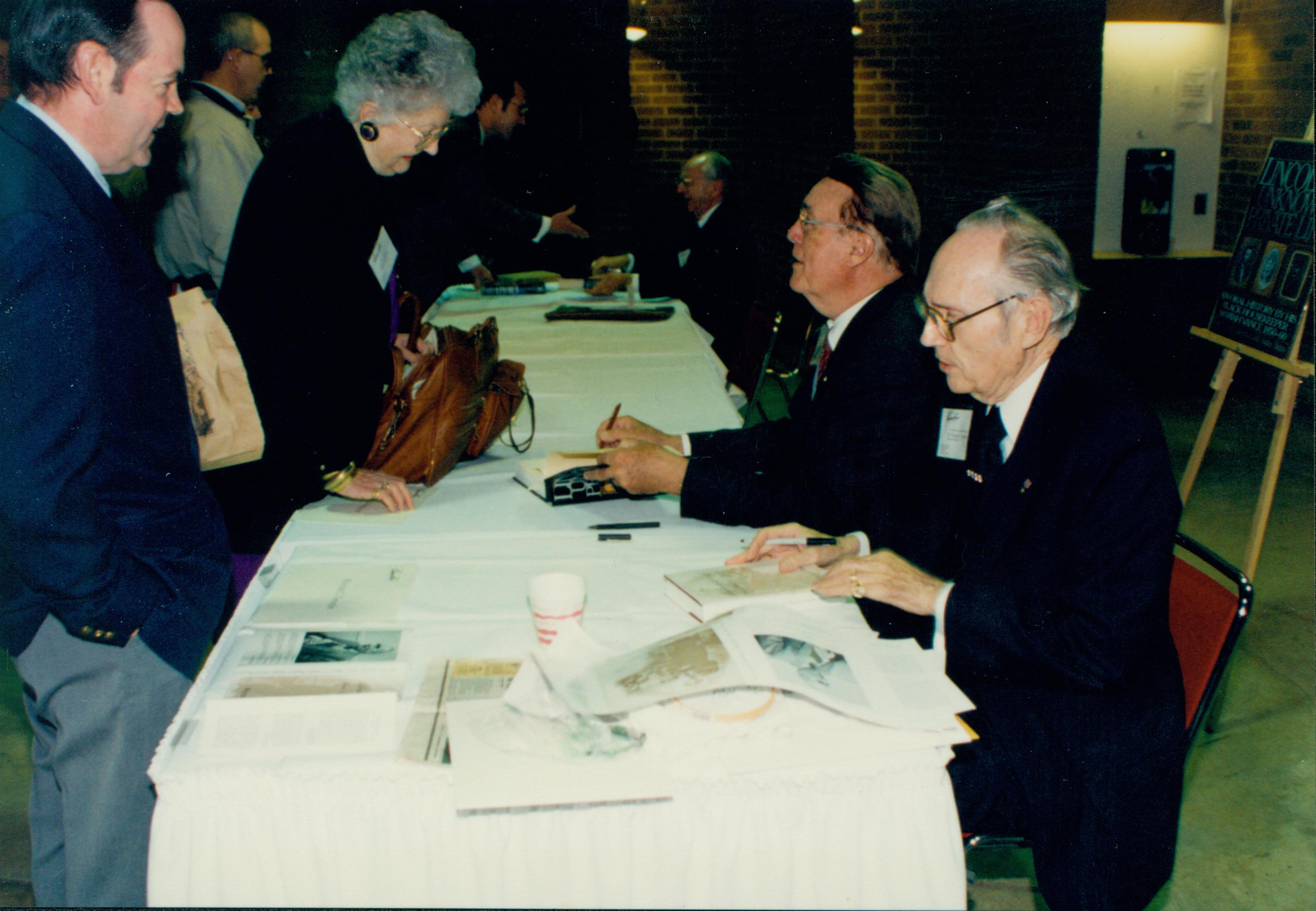 Two authors signing books Lincoln Colloquium Lincoln, Colloquium