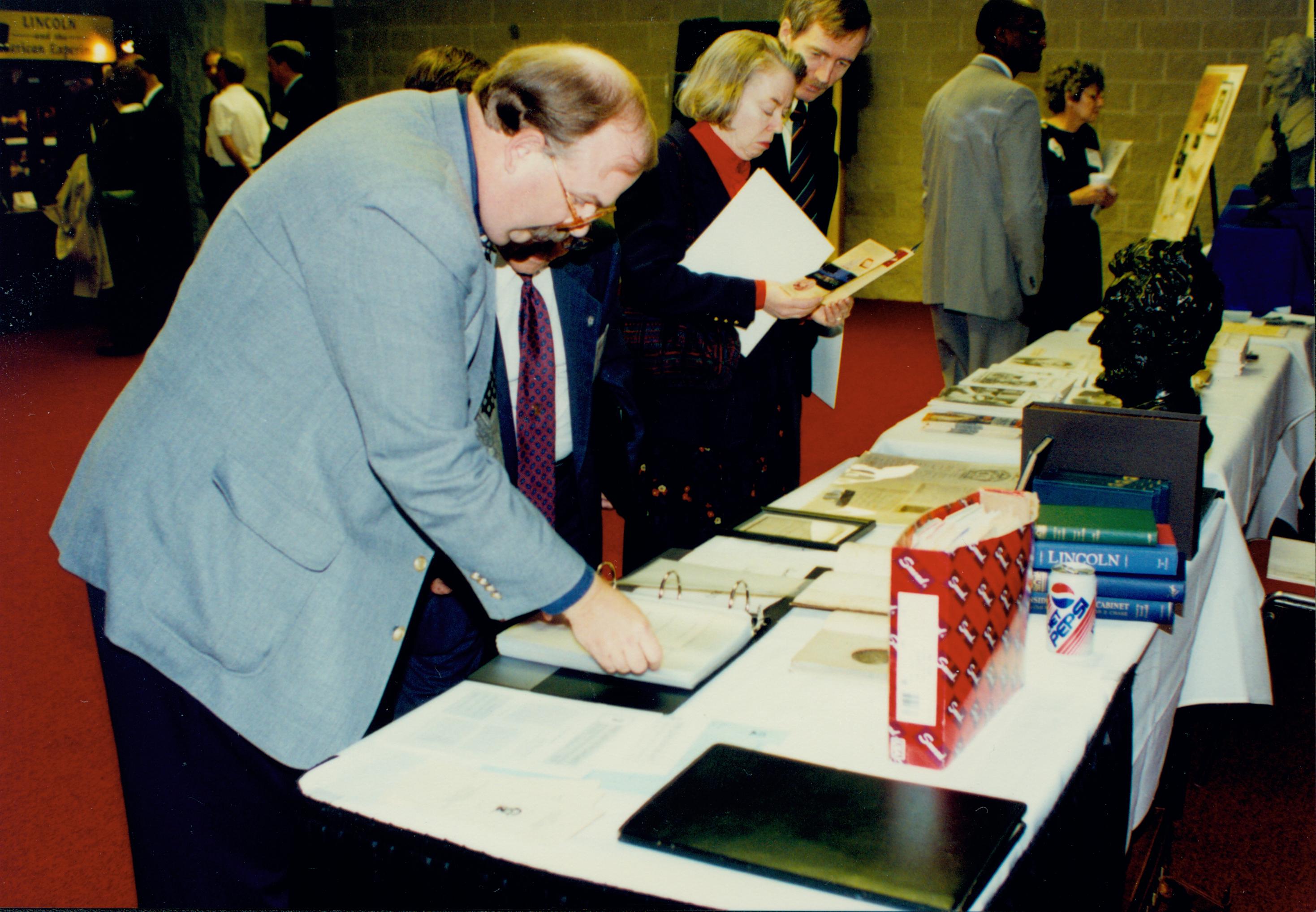 Attendees at literature table. Lincoln Colloquium Lincoln, Colloquium