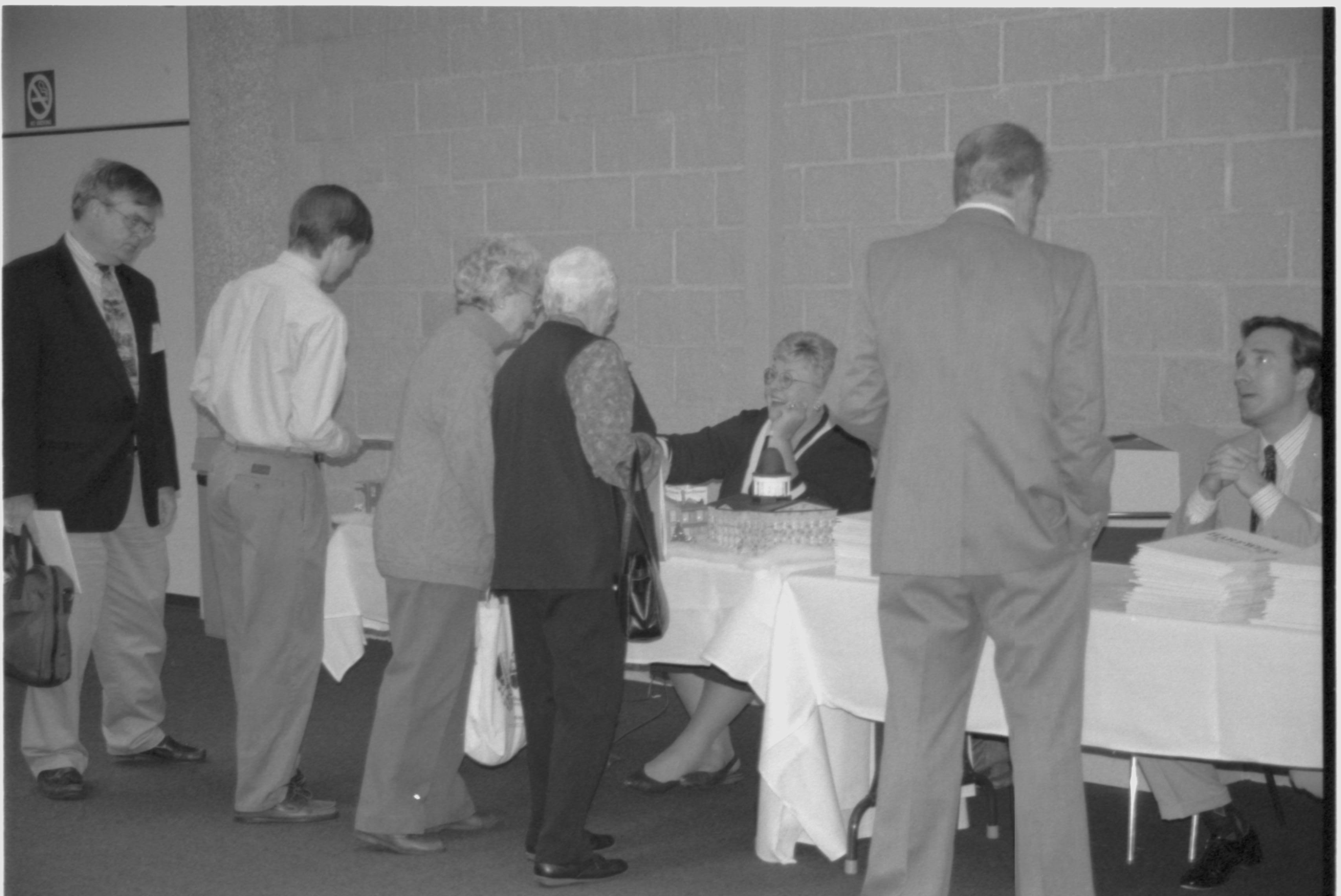 Attendees talking to authors at book table. Lincoln Colloquium; 88257 Lincoln, Colloquium